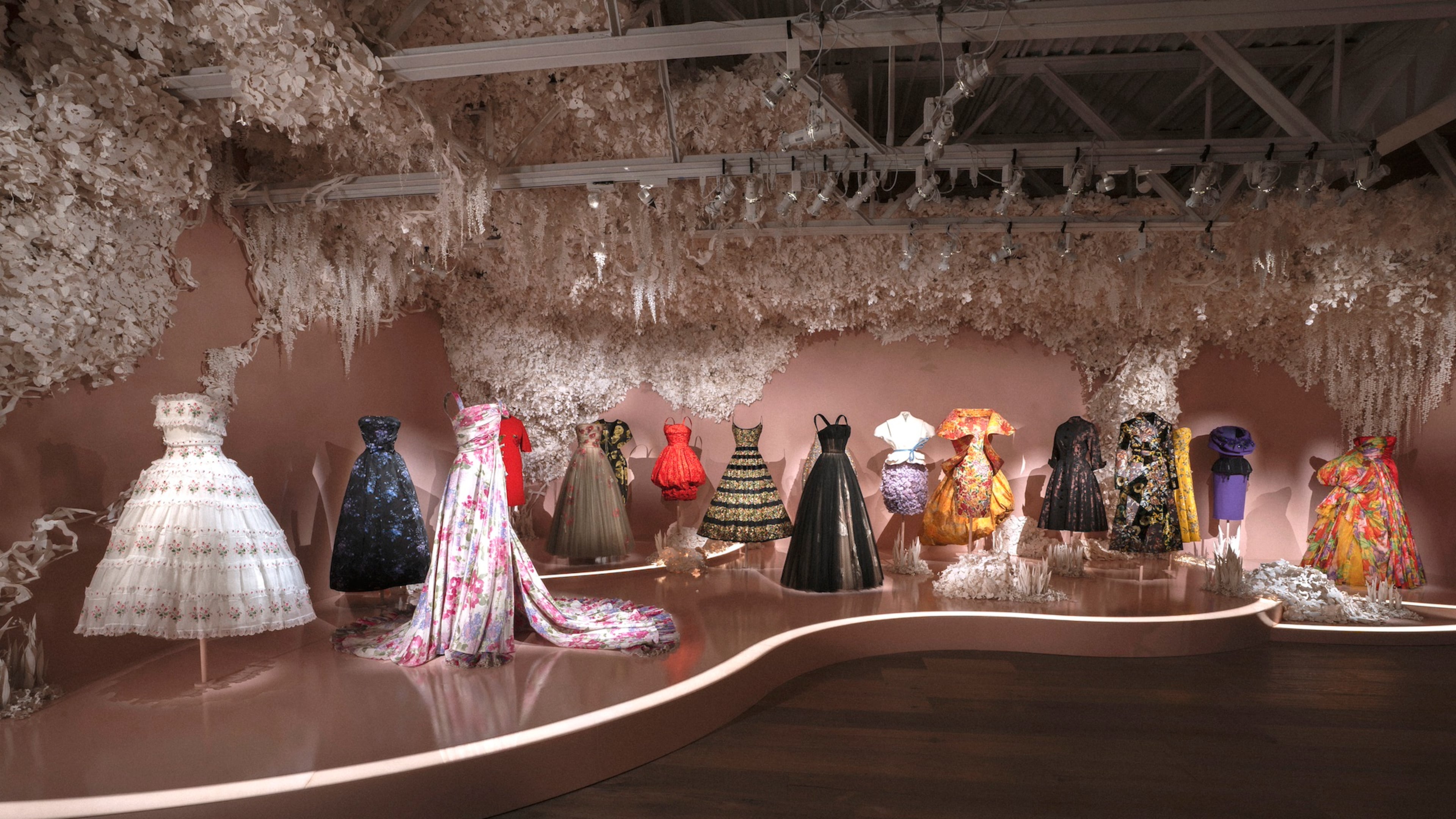 A selection of Dior dresses with floral themes is featured in the exhibition "Dior: Crafting Fashion." (Courtesy of SCAD FASH Museum of Fashion + Film)