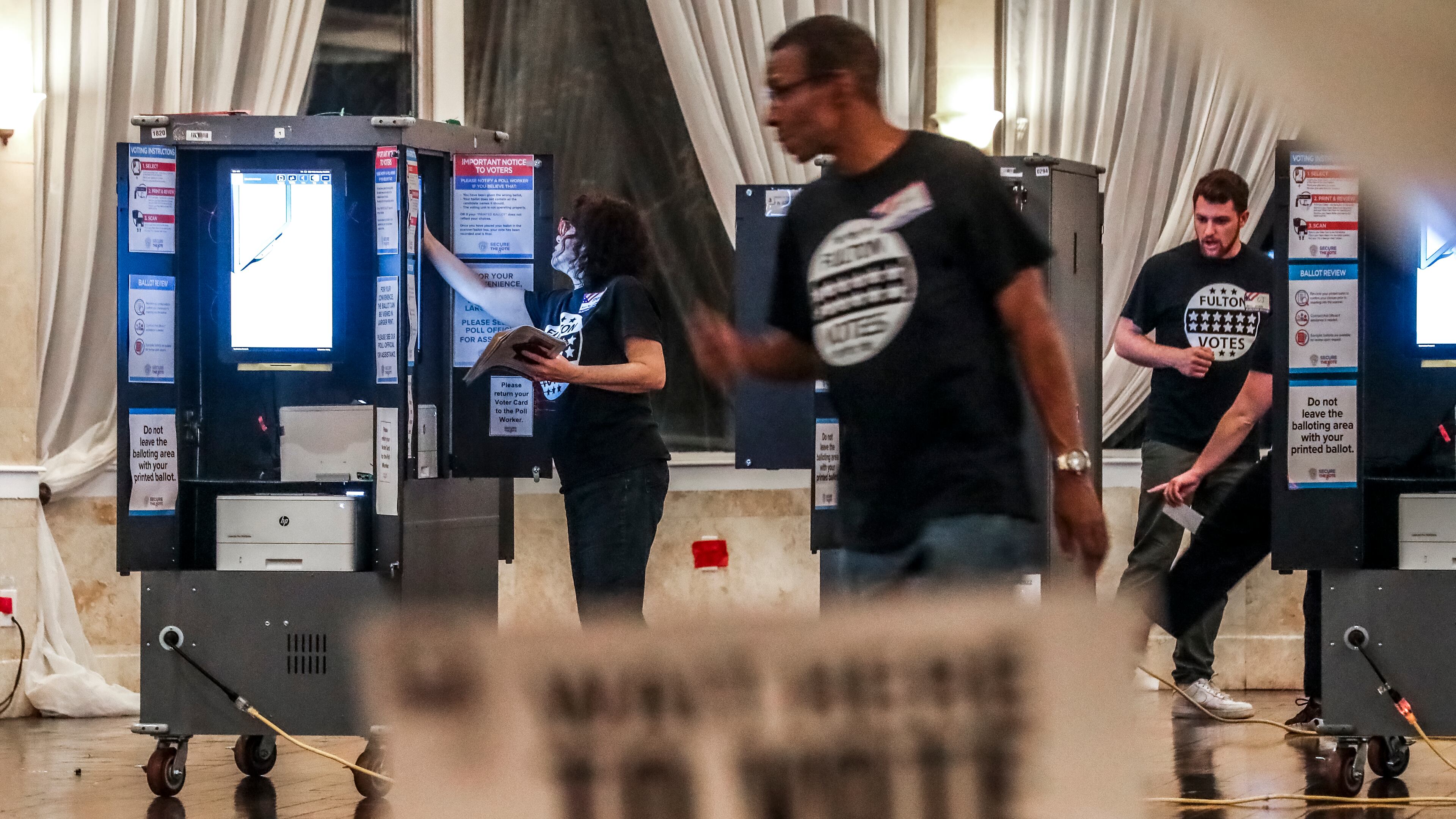 Poll workers prepare for voters on Tuesday, Nov. 8, 2022 at the Park Tavern in Atlanta. (John Spink / John.Spink@ajc.com)