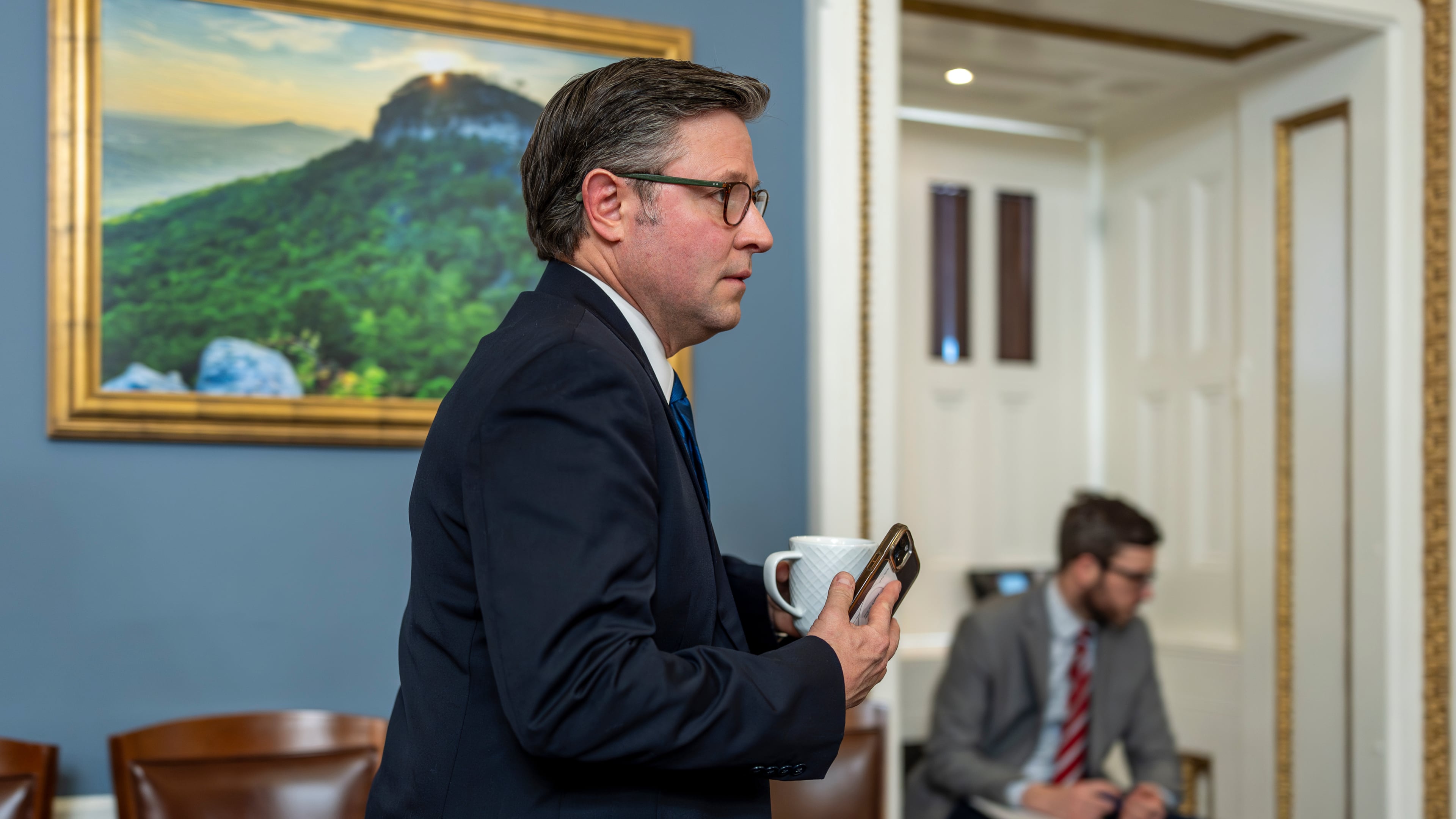 Speaker of the House Mike Johnson, R-La., walks through the House Rules Committee hearing room to meet with Republicans on the panel as they try to advance a federal funding package and prevent a prolonged partial government shutdown, at the Capitol in Washington, Monday, Feb. 2, 2026. (AP Photo/J. Scott Applewhite)