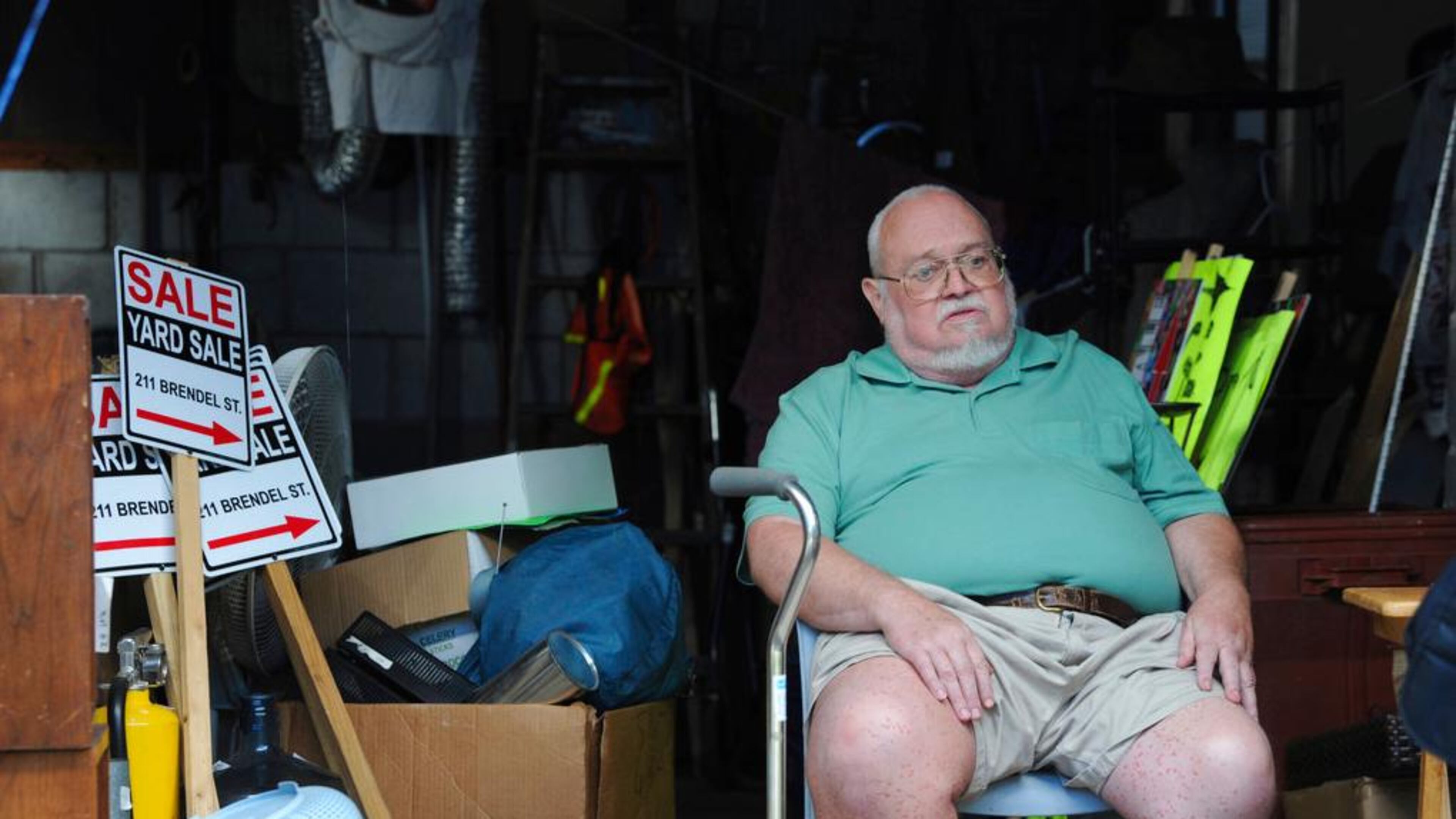 Willie Davis, a U.S. Navy veteran who is dying from cancer, sits in his garage among many of his belongings, which he's trying to sell to help pay for his own funeral, Wednesday, Sept. 26, 2018, in Johnstown, Pa. (John Rucosky/Tribune-Democrat via AP)