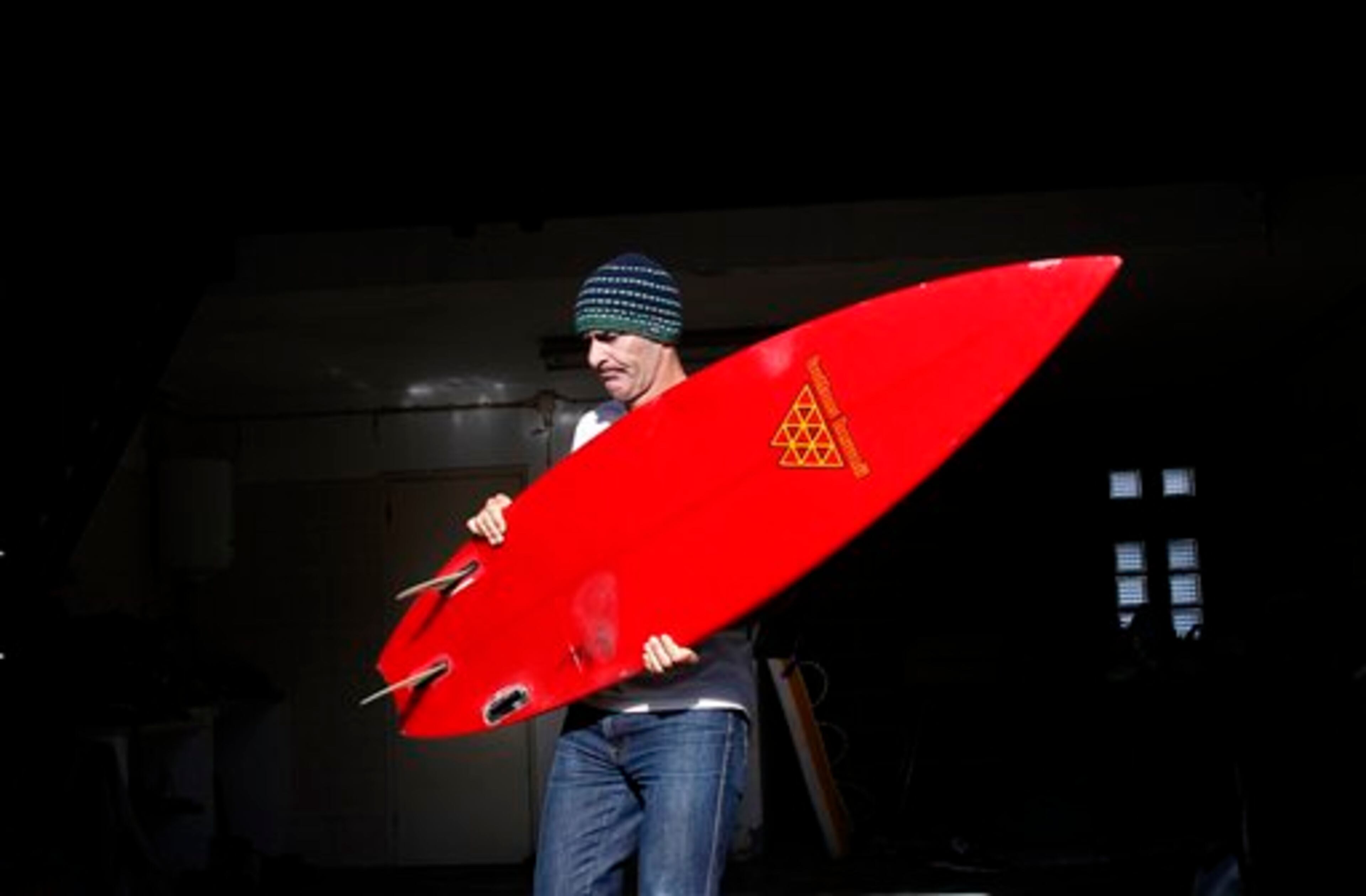 US surfer Garrett McNamara carries his surfboard before a surf session in Nazare, Portugal, Tuesday, Jan. 29, 2013. McNamara is said to have broken his own world record for the largest wave surfed when he caught a wave reported to be around 100ft off the coast of Nazare on Monday. If the claims are verified, it will mean that McNamara, who was born in Pittsfield, Massachusetts but whose family moved to Hawaii's North Shore when he was aged 11, has beaten his previous record, which was also set at Nazare, of 23.77 meters (78 feet) in November 2011. (AP Photo/Francisco Seco)