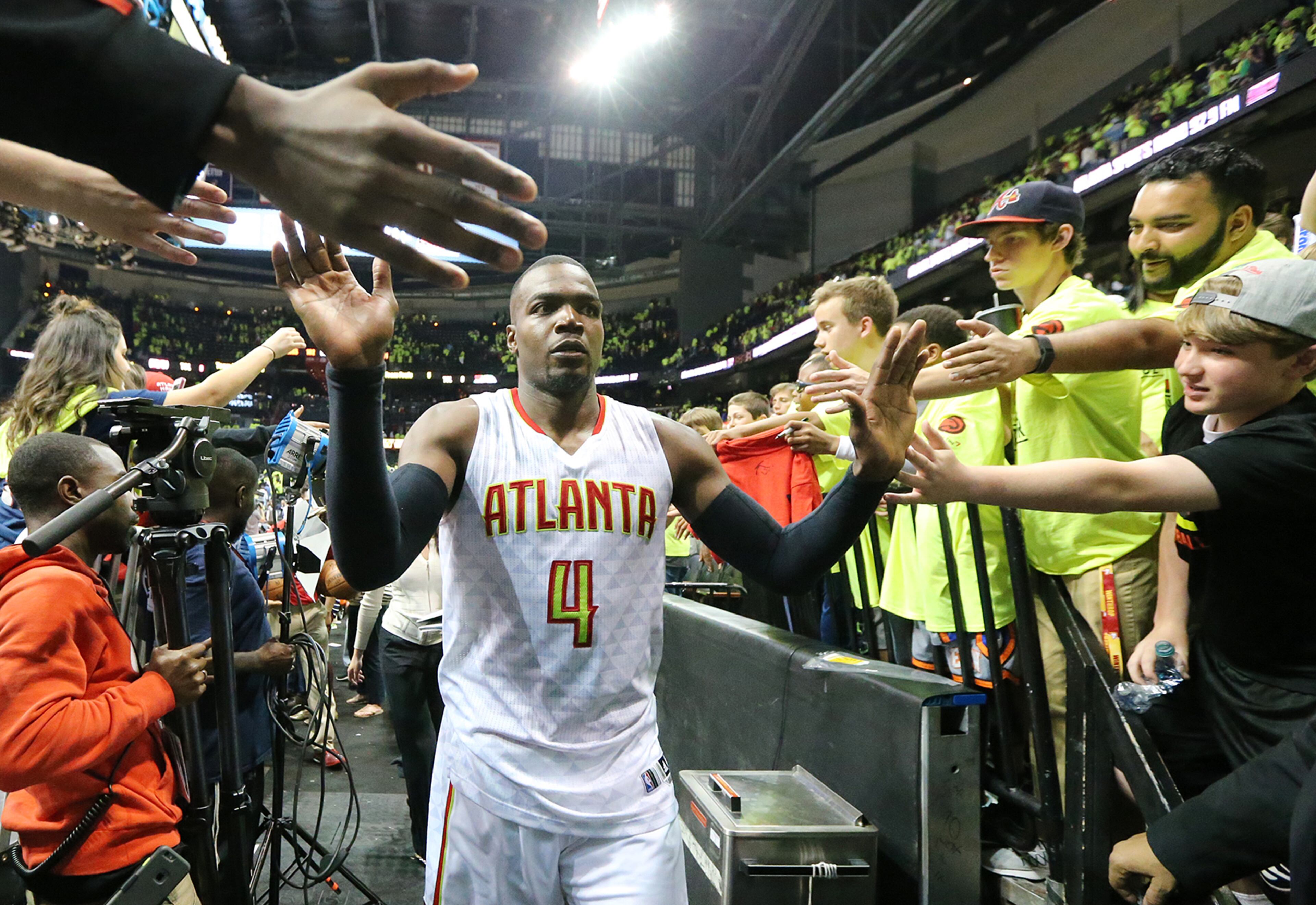 041616 ATLANTA: Hawks Paul Millsap celebrates with fans as the Hawks beat the Celtics 102-101 in game one of their NBA Eastern Conference first round playoff game at Philips Arena on Saturday, April 16, 2016. Curtis Compton / ccompton@ajc.com
