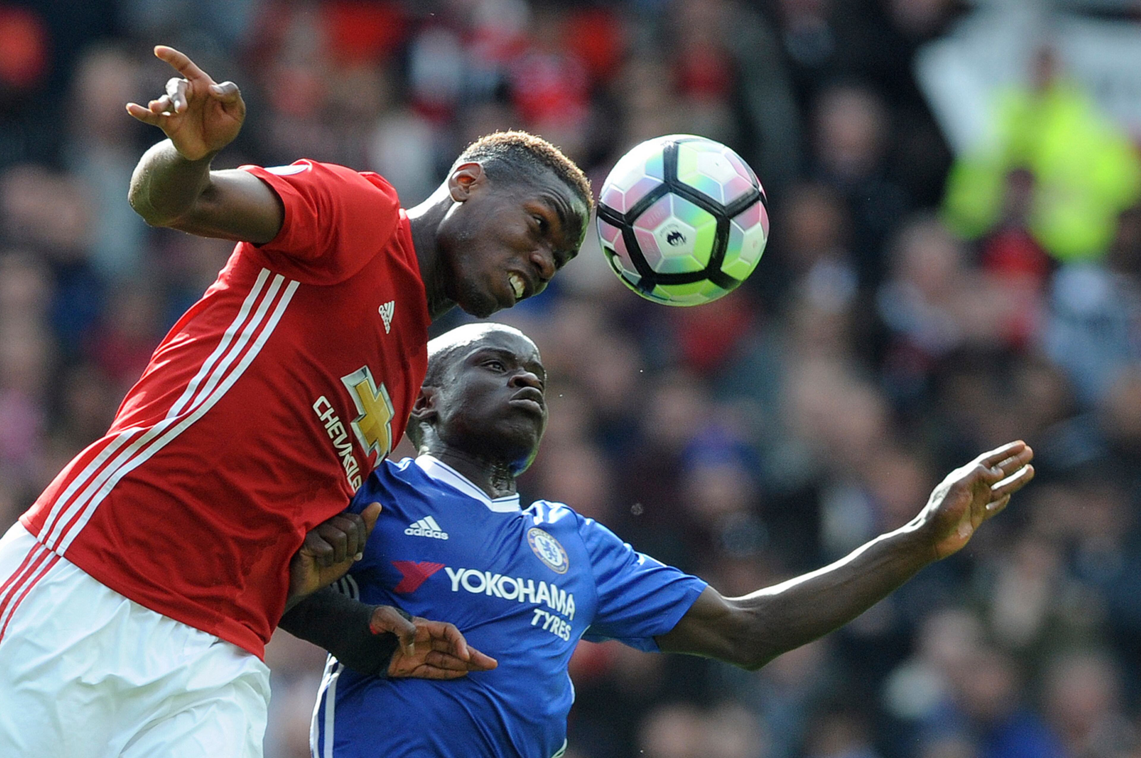 Manchester United's Paul Pogba and Chelsea's N'Golo Kante, rear, challenge for the ball during the English Premier League soccer match between Manchester United and Chelsea at Old Trafford stadium in Manchester, Sunday, April 16, 2017.(AP Photo/ Rui Vieira)
