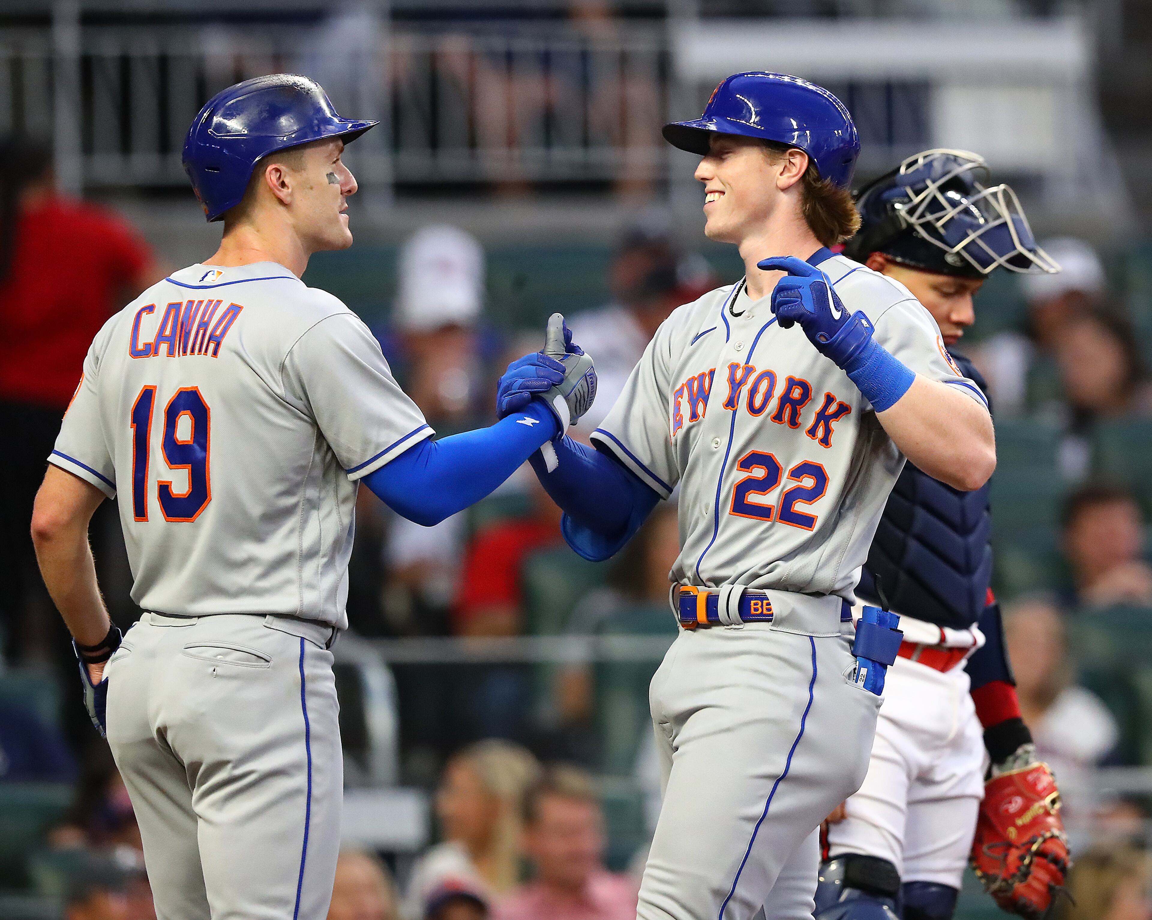 081722 Atlanta: New York Mets Brett Baty (right) gets five from Mark Canha hitting a 2-RBI home run to take a 4-0 lead over the Atlanta Braves for the first home run of his major league career in his very first at-bat during the second inning in a MLB baseball game on Wednesday, August 17, 2022, in Atlanta. Braves catcher William Contreras reacts to falling behind early in the game. “Curtis Compton / Curtis Compton@ajc.com