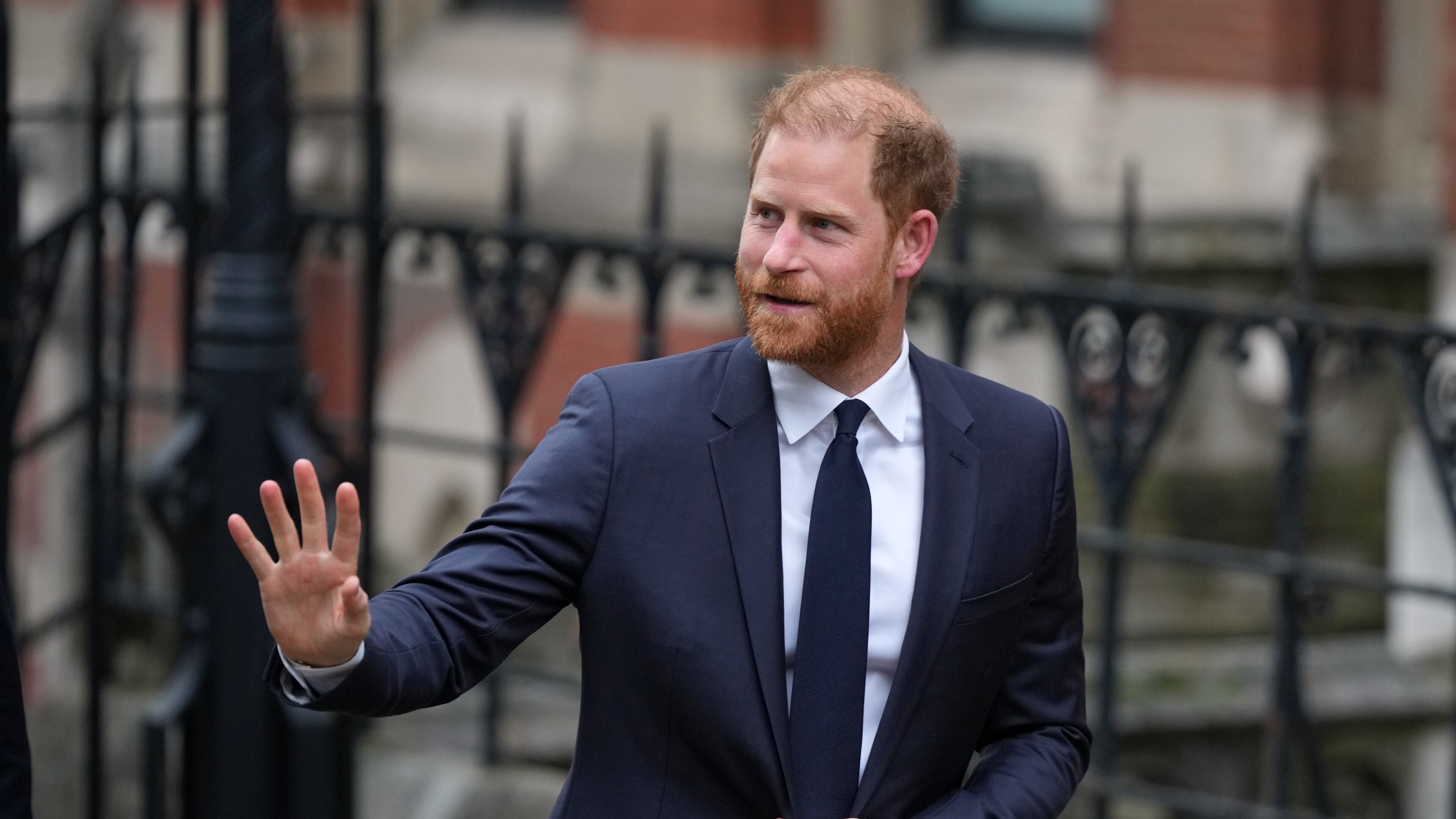 Britain's Prince Harry waves as he arrives at London's High Court to lead a group, including Elton John and Elizabeth Hurley, accusing the Daily Mail's publisher of privacy invasion through unlawful tactics in a trial that is part of a wider phone hacking scandal in London, Monday, Jan. 19, 2026. (AP Photo/Alastair Grant)