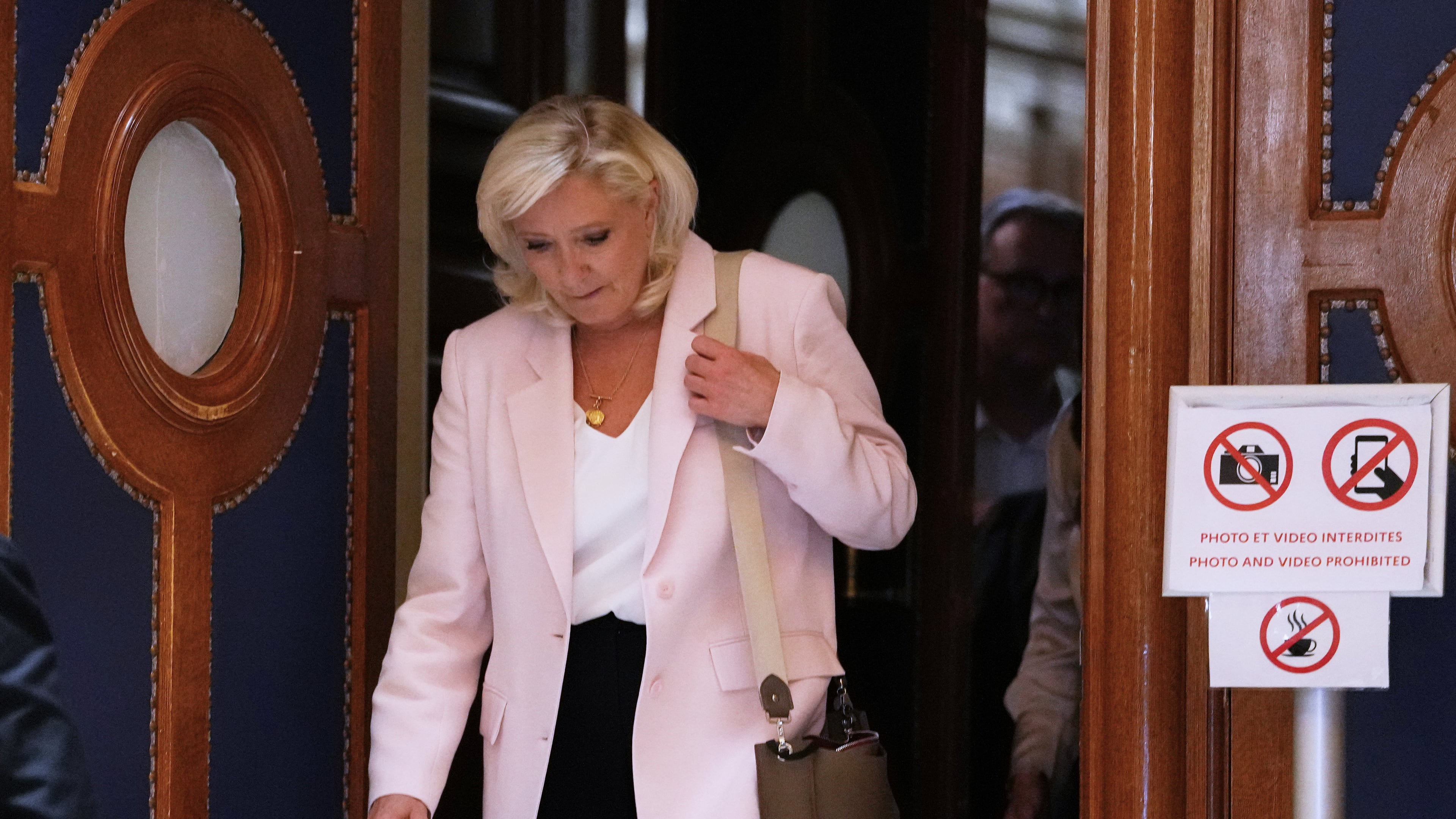 Far-right leader Marine Le Pen leaves the courtroom after the verdict of her appeal trial, in Paris, France, Tuesday, July. 7, 2026. (AP Photo/Aurelien Morissard)