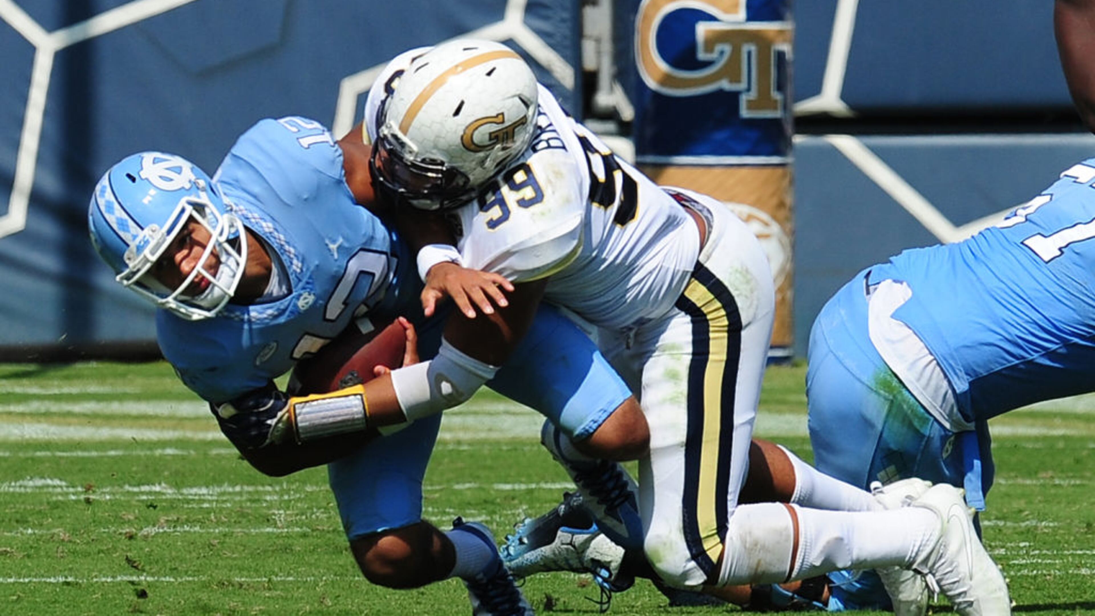 ATLANTA, GA - SEPTEMBER 30: Chazz Surratt #12 of the North Carolina Tar Heels is sacked by Desmond Branch #99 of the Georgia Tech Yellow Jackets on September 30, 2017 in Atlanta, Georgia. Photo by Scott Cunningham/Getty Images)