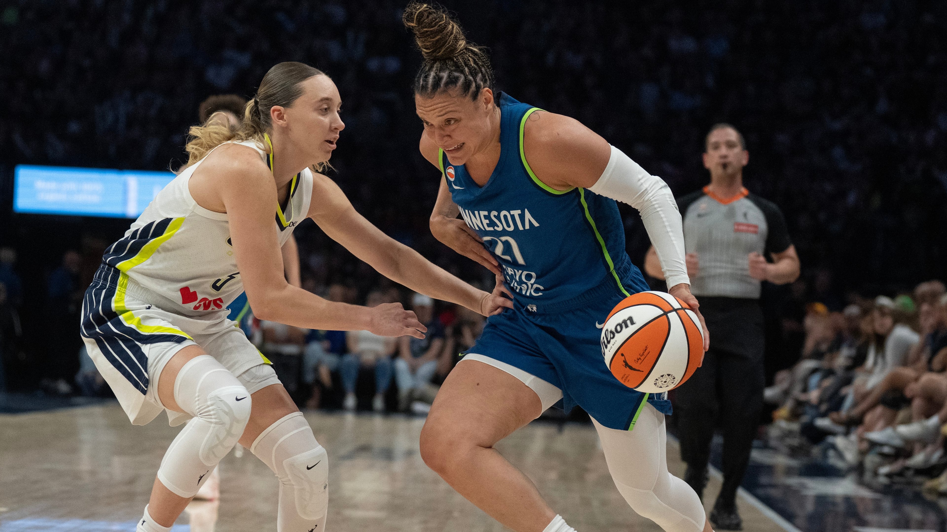 Minnesota Lynx guard Kayla McBride (21) drives to the basket on Dallas Wings guard Paige Bueckers in the first half of a basketball game, Sunday Aug. 9, 2026 in Minneapolis. (Jerry Holt/Minnesota Star Tribune via AP)