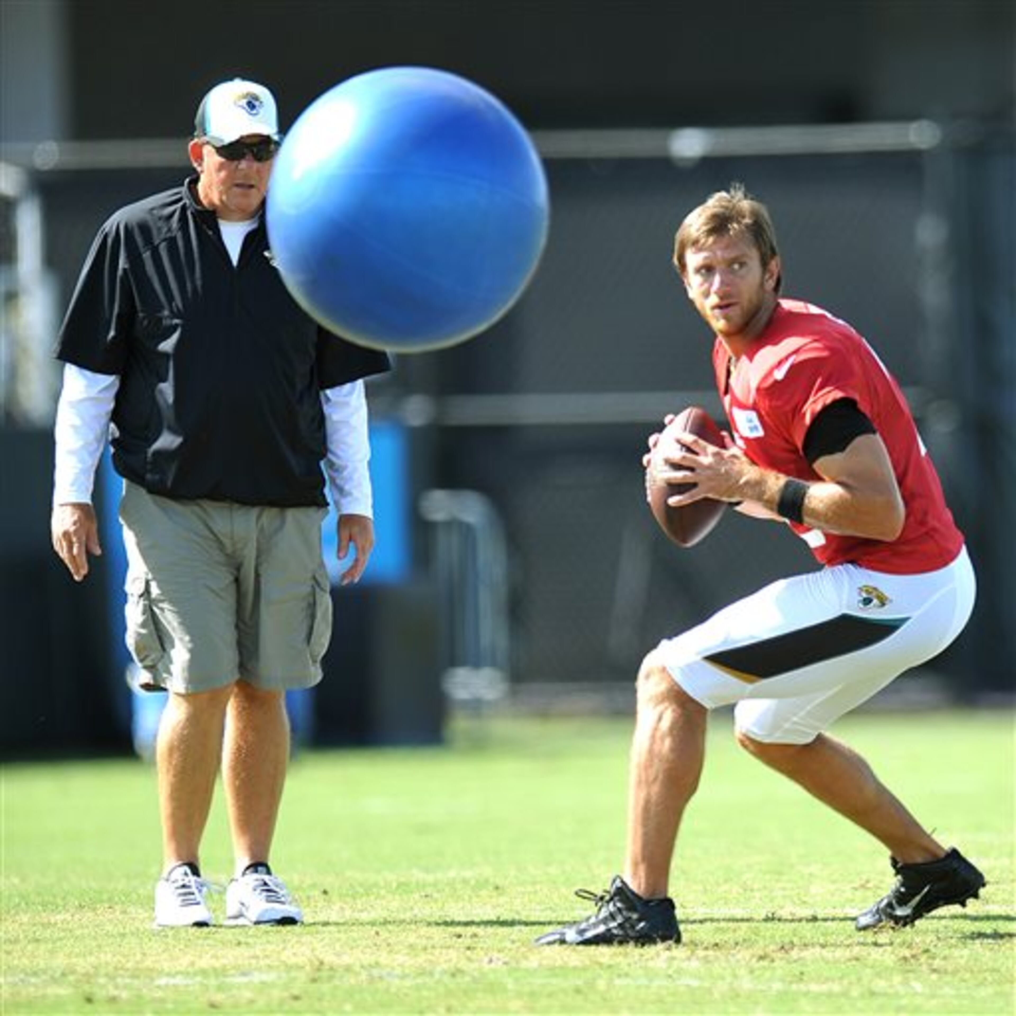 A large blue ball is bounced at Ricky Stanzi as the quarterback drops back to pass during the Jacksonville Jaguars' NFL football training camp Tuesday, Aug. 5, 2014, in Jacksonville, Fla. (AP Photo/Florida Times-Union, Bruce Lipsky) during NFL football training camp Tuesday, Aug. 5, 2014, in Jacksonville, Fla. (AP Photo/The Florida Times-Union, Bruce Lipsky)