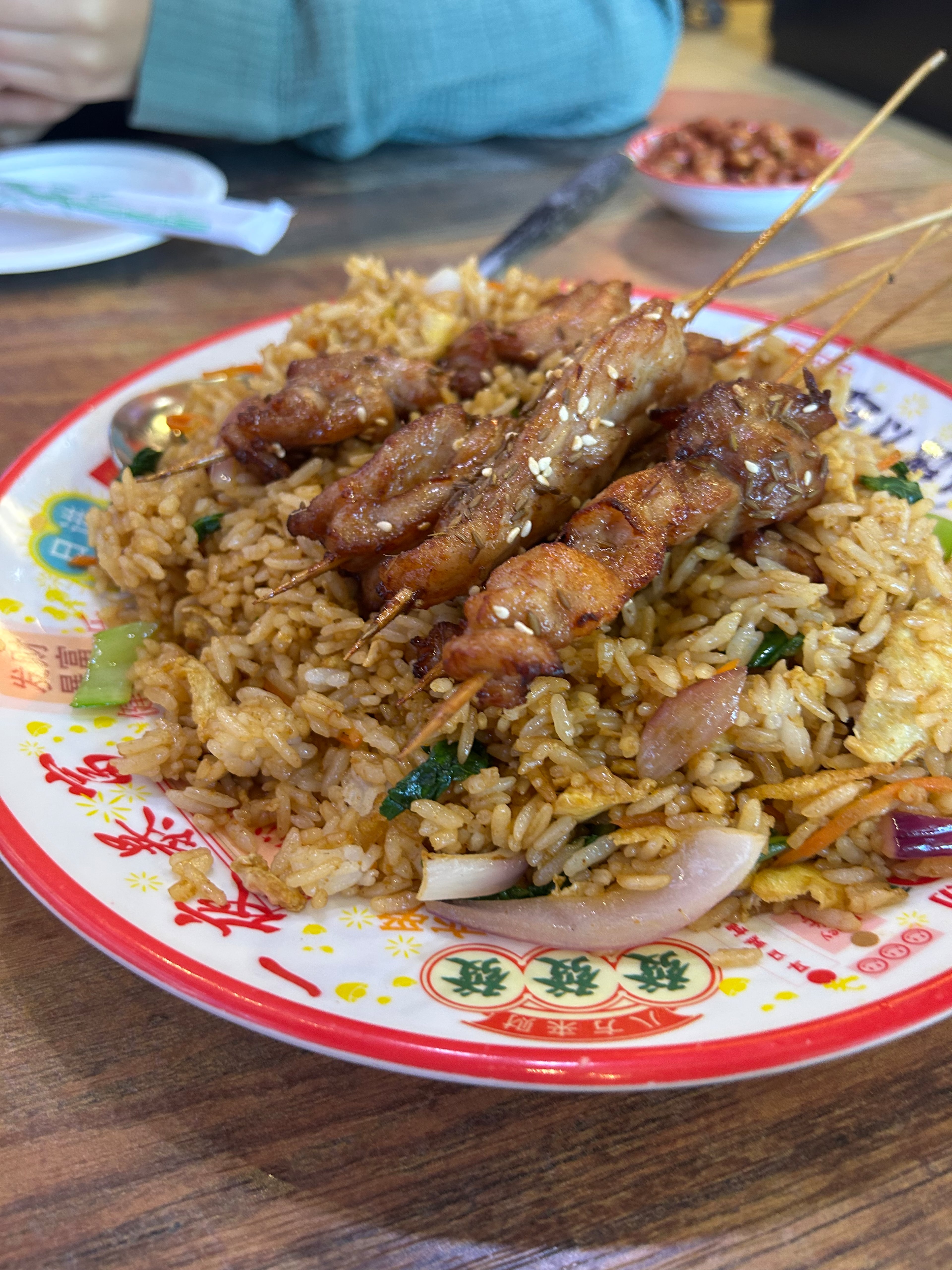 Chicken skewers with fried rice at Crazy Skewers in Doraville. (Candy Hom for the AJC)