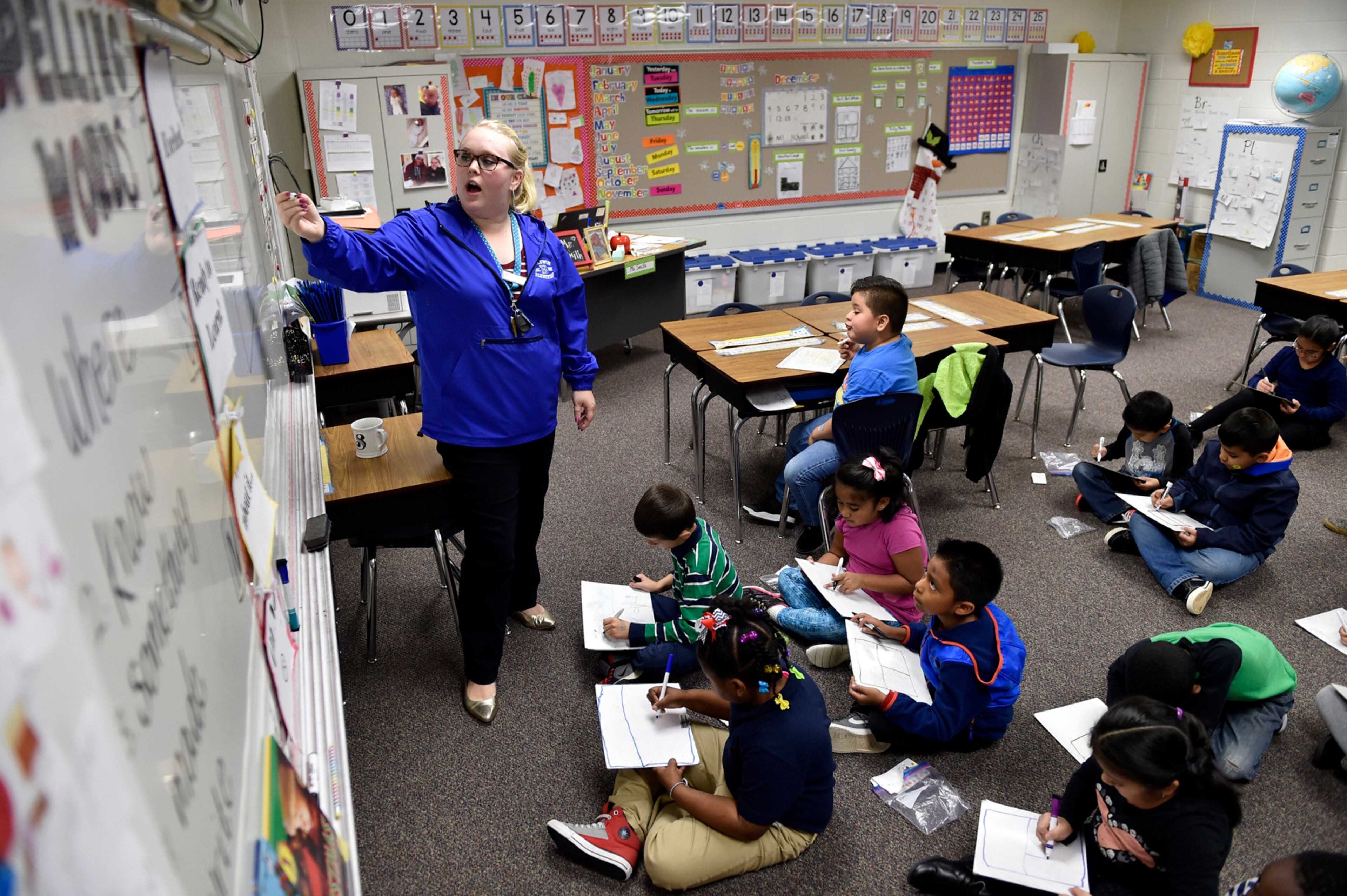 December 14, 2016, Norcross - Audrey Smith, 25, a first grade teacher at Baldwin Elementary School, draws a picture on the whiteboard for a class exercise in Norcross, Georgia, on Wednesday, December 14, 2016. Despite never having taught her own class before this year, Smith leads like a veteran teacher. (DAVID BARNES / DAVID.BARNES@AJC.COM)