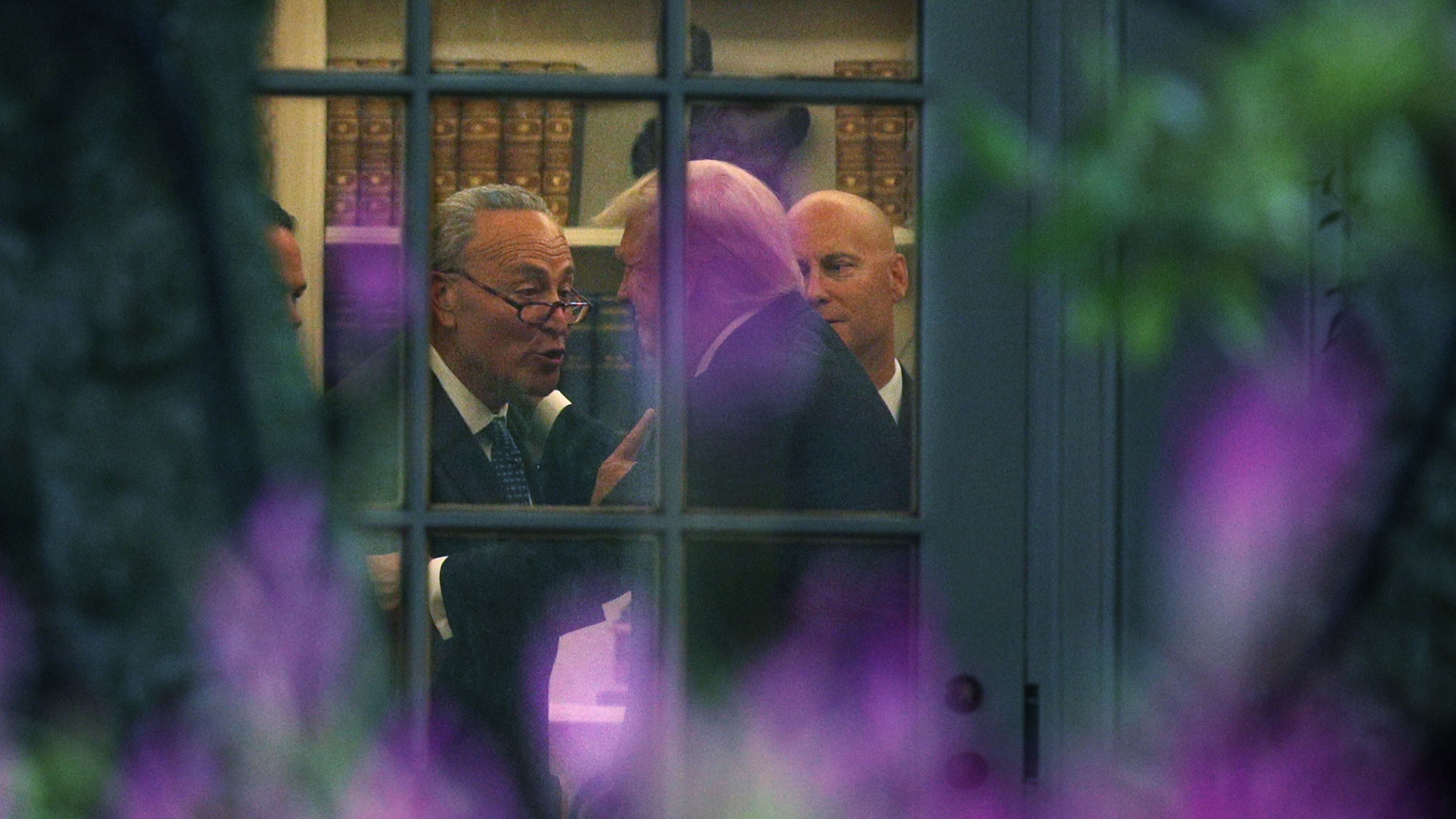 Senate Minority Leader Chuck Schumer (D-N.Y.), left, makes a point to President Donald Trump in the Oval Office on September 6, 2017. (Photo by Alex Wong/Getty Images)
