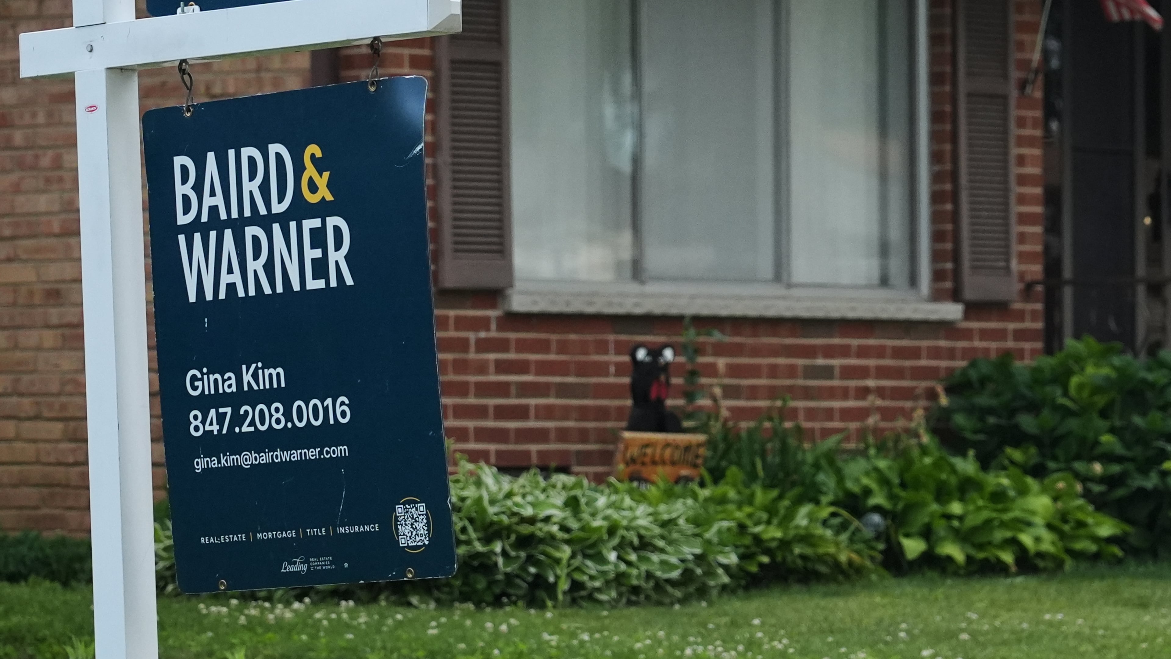 For sale sign is seen outside of a home in Wheeling, Ill., Monday, June 8, 2026. (AP Photo/Nam Y. Huh)