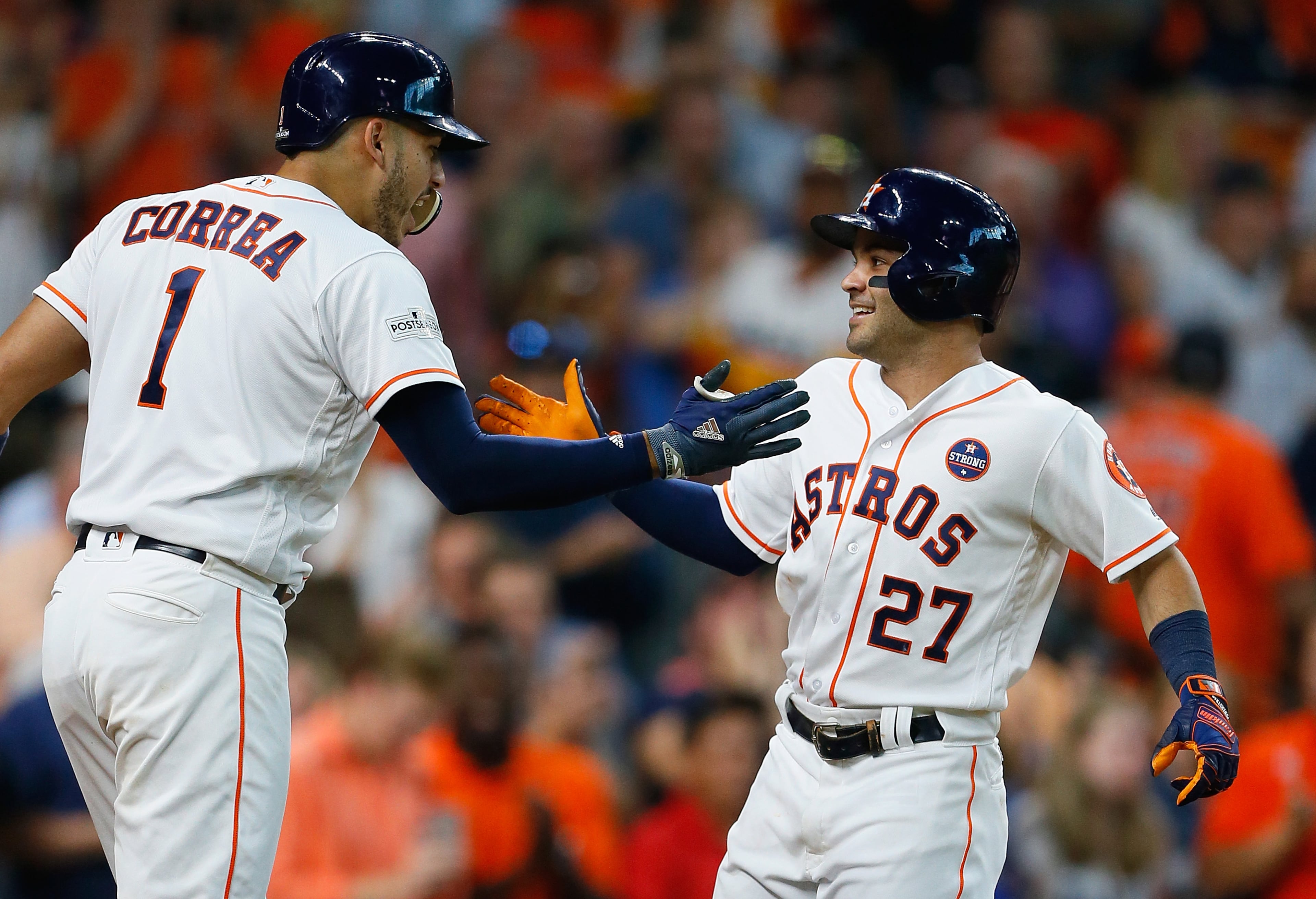 HOUSTON, TX - OCTOBER 05: Jose Altuve #27 of the Houston Astros celebrates with Carlos Correa #1 after hitting a home run in the seventh inning against the Boston Red Sox during game one of the American League Division Series at Minute Maid Park on October 5, 2017 in Houston, Texas. (Photo by Bob Levey/Getty Images)