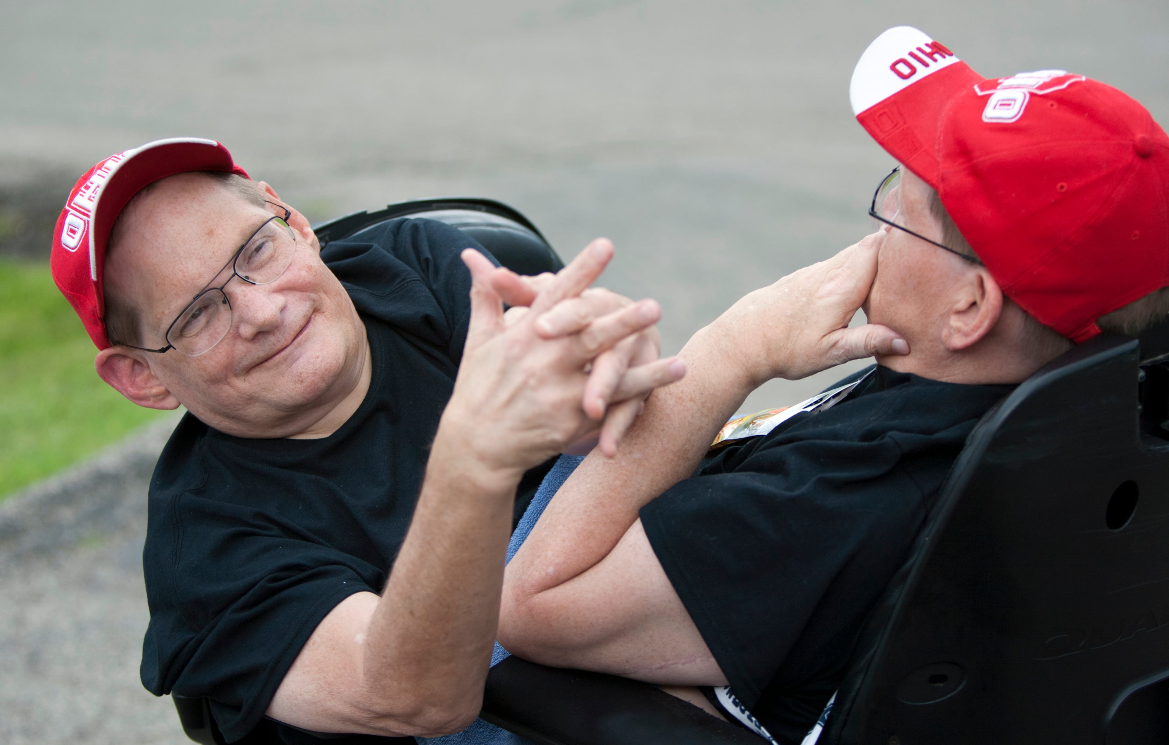 Donnie, left, and Ronnie Galyon, 62, travel inside their wheelchair near their Beavercreek, Ohio, home Saturday, June 28, 2014. The brothers, born Oct. 28, 1951, are hoping to be recognized later this year as the world's oldest conjoined twins. That could happen in October, when they would turn 63 and pass the record held by conjoined twins from Italy. (AP Photo/The Grand Rapids Press, Cory Morse)