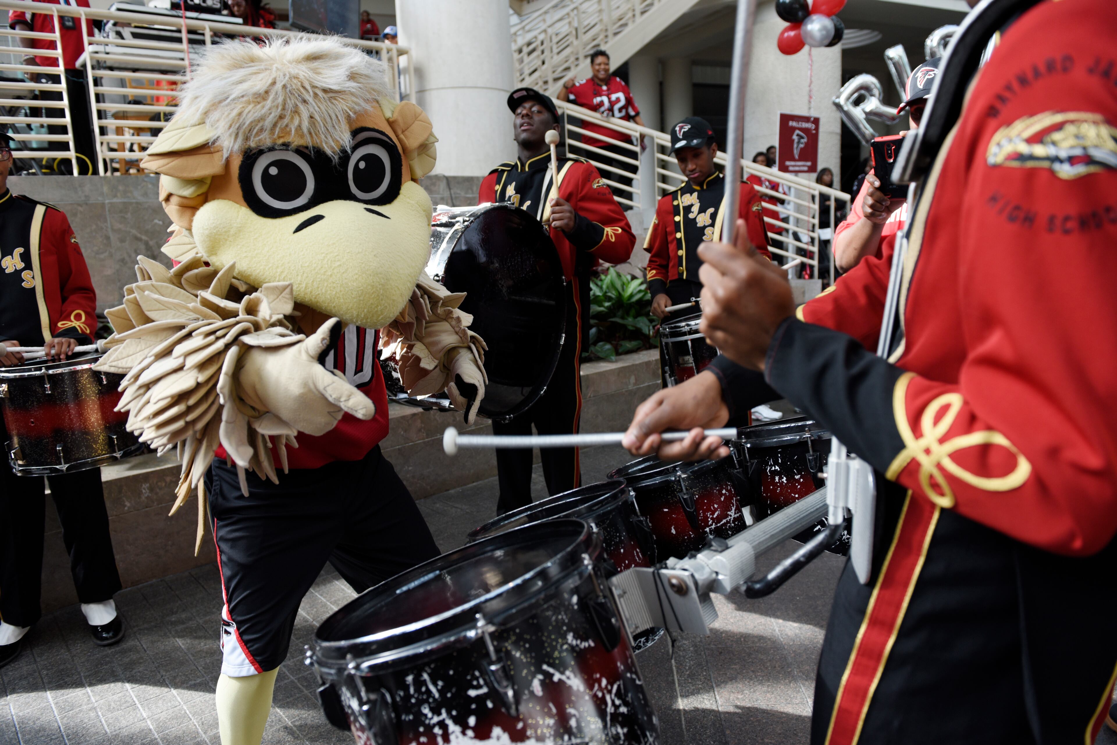 January 20, 2017, Atlanta - Freddie Falcon dances with members of the Maynard Holbrook Jackson high school marching band during a pep rally for the upcoming NFC Championship game against the Packers in Atlanta, Georgia, on Friday, January 20, 2017. (DAVID BARNES / DAVID.BARNES@AJC.COM)
