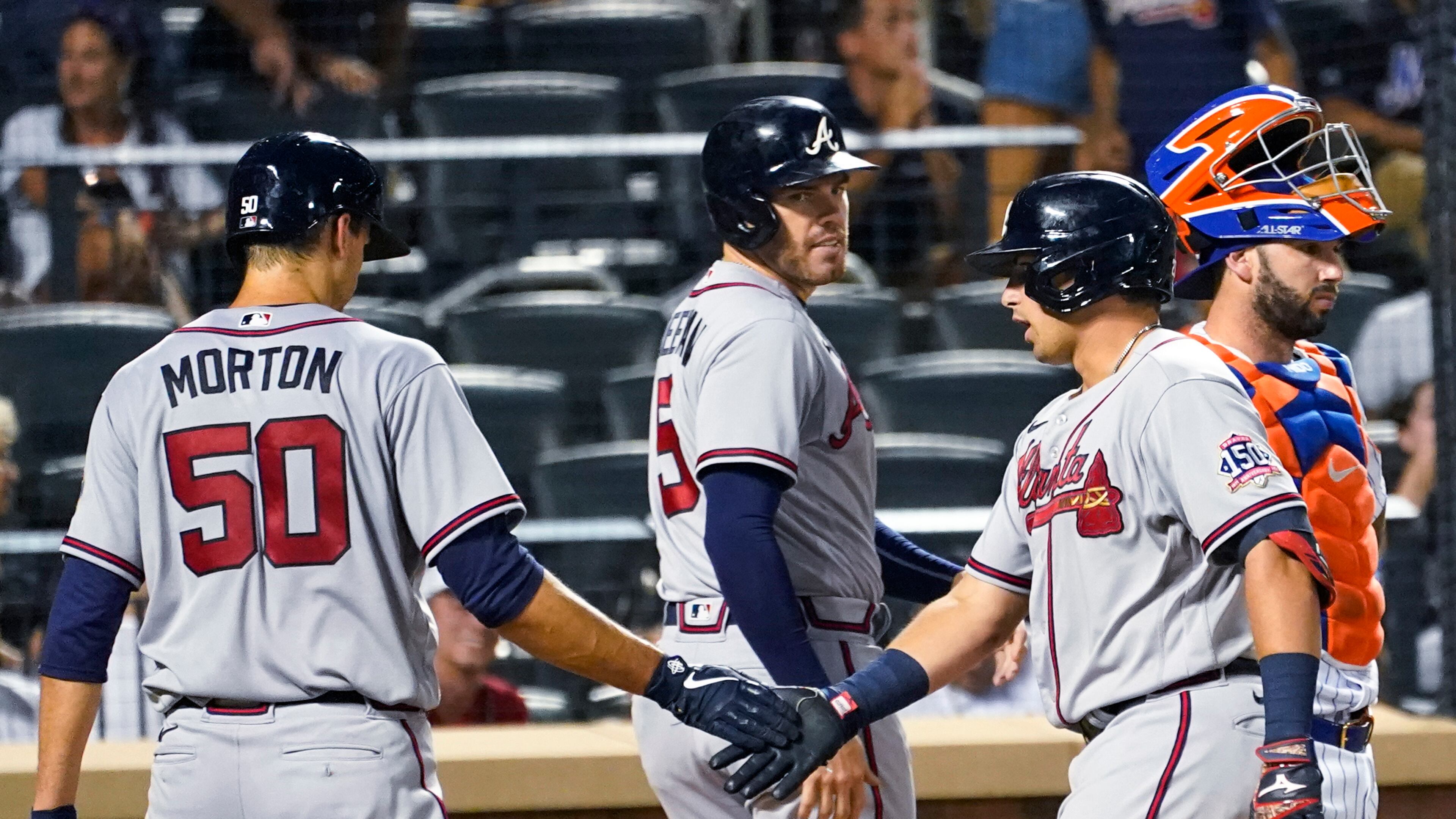 Atlanta Braves' Austin Riley, right front, celebrates with Charlie Morton (50) and Freddie Freeman (5) after they scored on Riley's grand slam during the fourth inning of the team's baseball game against the New York Mets, Tuesday, July 27, 2021, in New York. (AP Photo/Mary Altaffer)