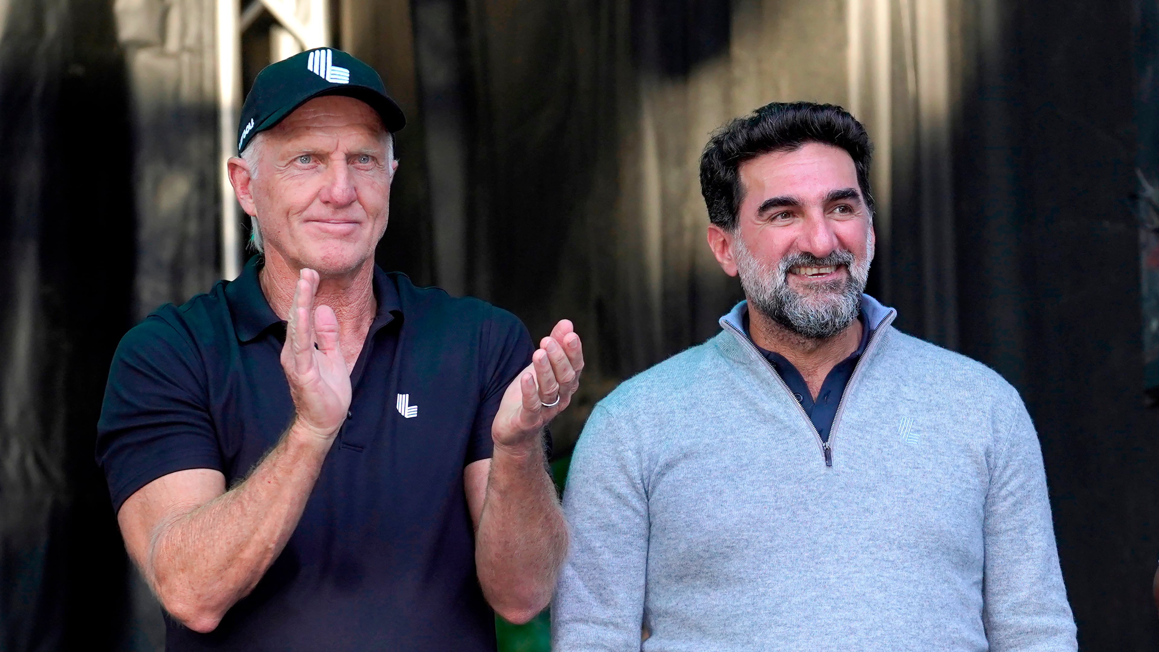 FILE - LIV Golf CEO Greg Norman, left, applauds Yasir Al-Rumayyan, Governor of Public Investment Fund of Saudi Arabia, at the LIV Golf Invitational-Chicago tournament Sept. 18, 2022, in Sugar Hill, Ill. (AP Photo/Charles Rex Arbogast, File)