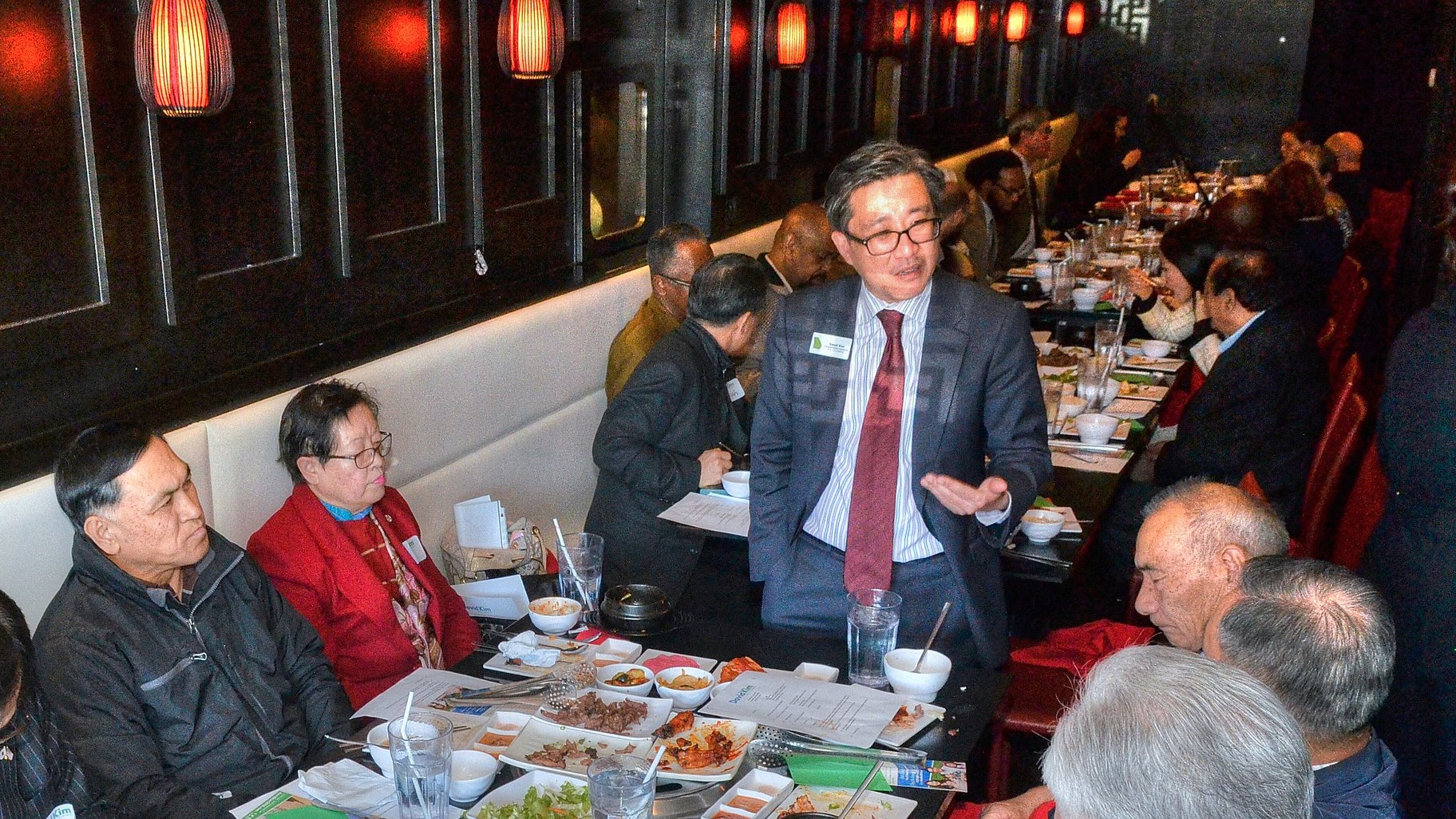 David Kim (standing), the son of South Korean immigrants, speaks with guests and supporters during a recent campaign luncheon. A Democrat, he is running in the 7th Congressional District rooted in Gwinnett and Forsyth counties. (Photo by Chris Hunt/Special)