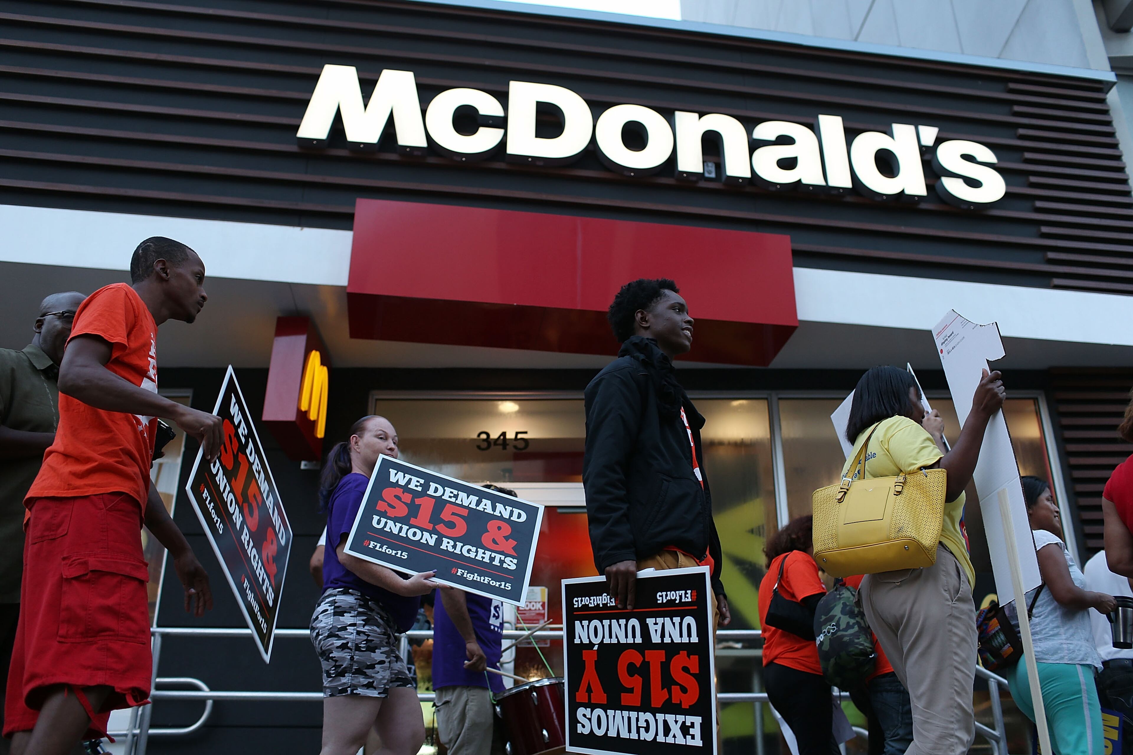 MIAMI, FL - NOVEMBER 10: Workers protest outside a McDonald's restaurant on November 10, 2015 in Miami, Florida. The protesters are demanding action from state legislators and presidential candidates to raise the minimum wage to $15 an hour. (Photo by Joe Raedle/Getty Images)
