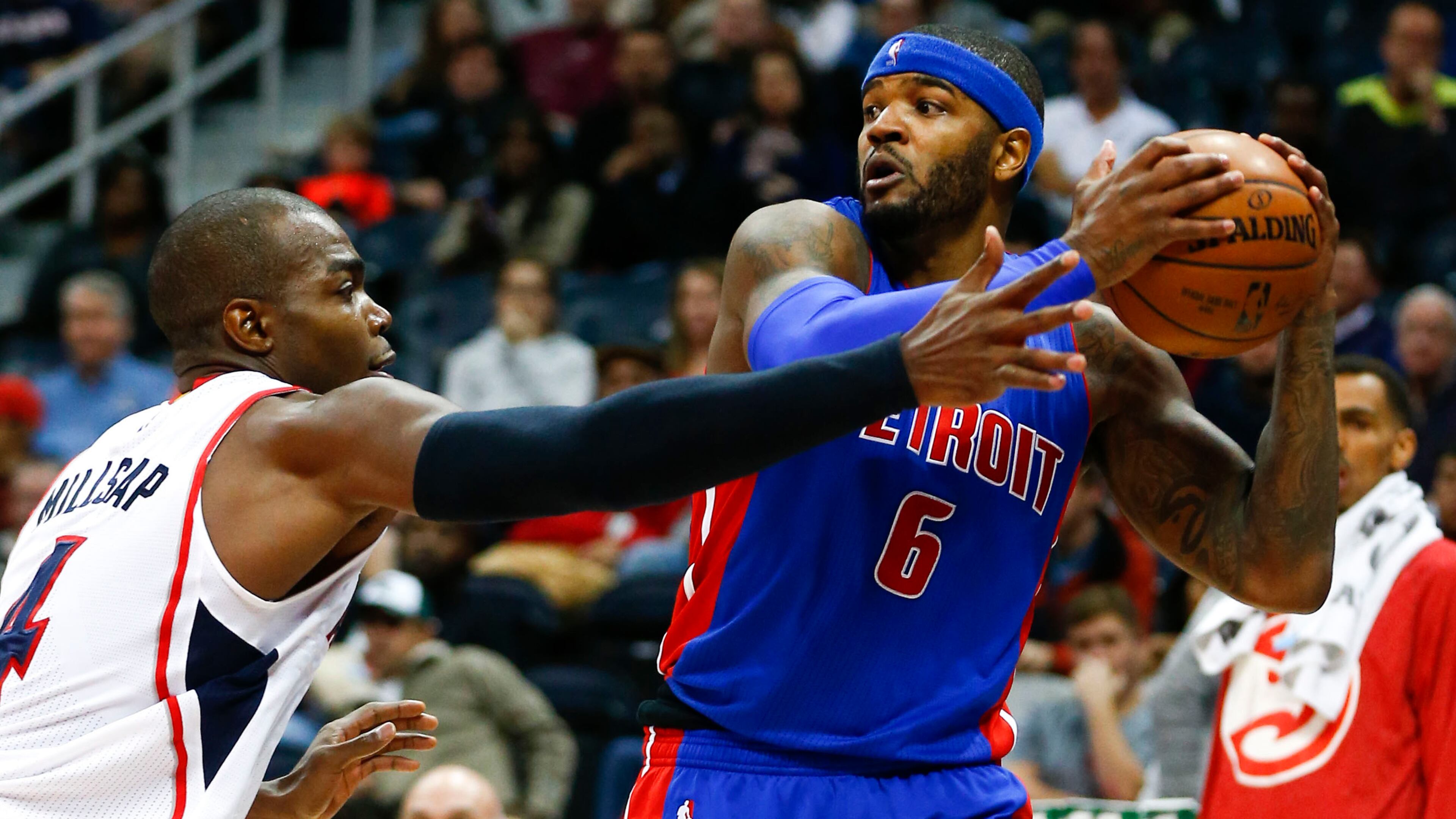 Detroit Pistons forward Josh Smith (6) looks for a open man as Atlanta Hawks forward Paul Millsap (4) defends in the second half of an NBA basketball game Friday, Nov. 21, 2014, in Atlanta. Atlanta won 99-89. (AP Photo/John Bazemore)