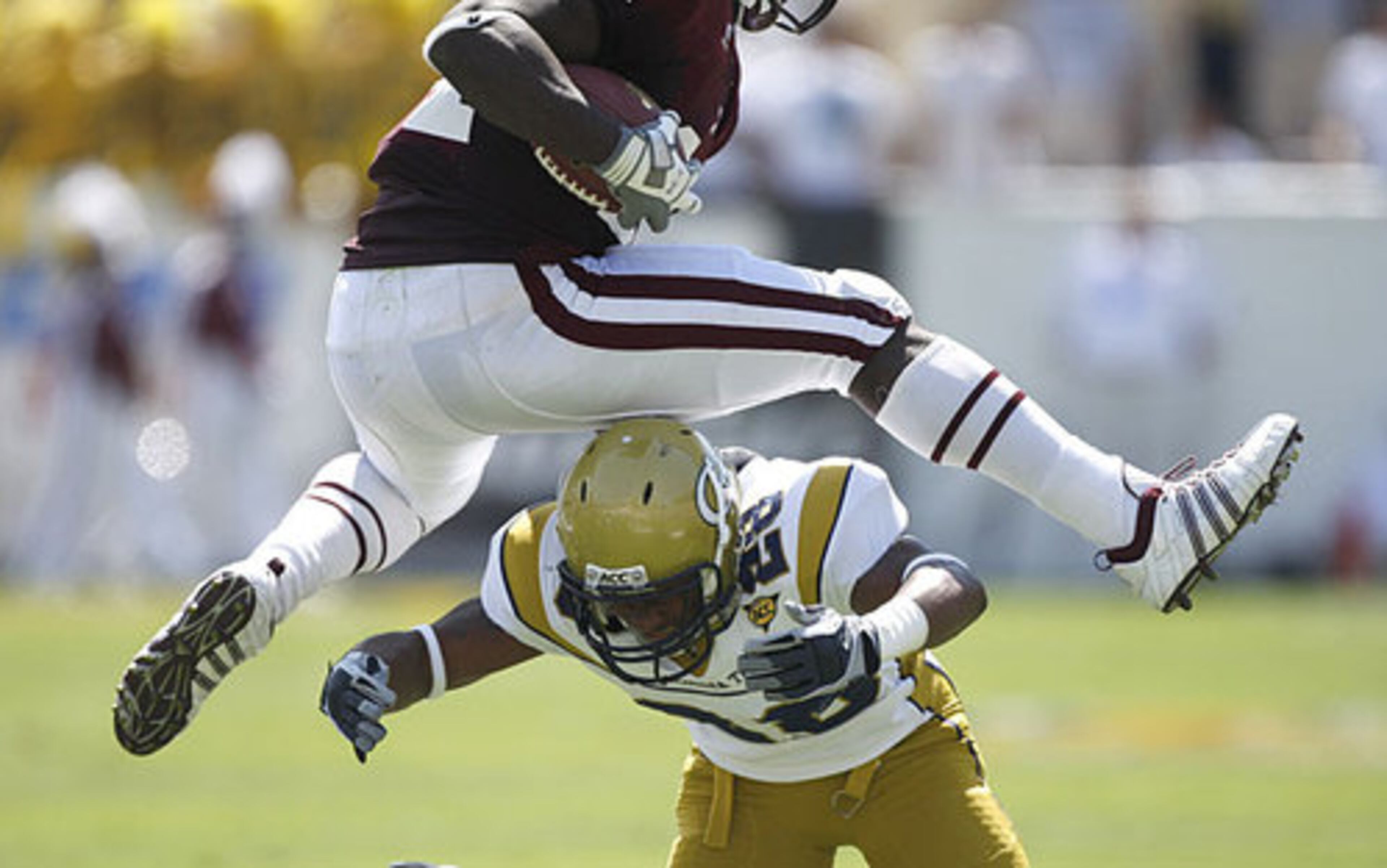Mississippi State's Anthony Dixon jumps over the top of Georgia Tech's Rashad Reid in the second quarter.