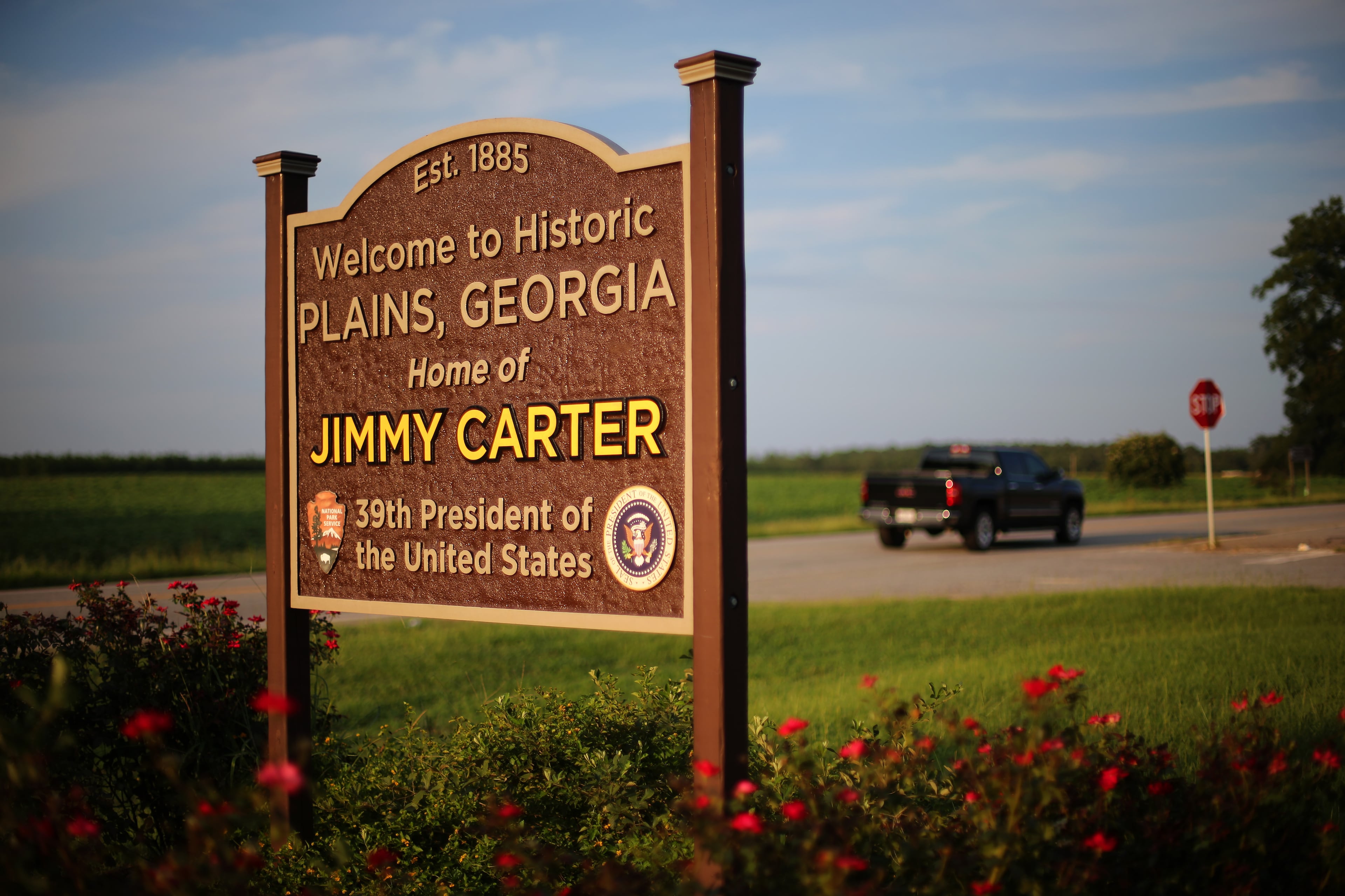 The Plains welcome sign glows in the late evening sun Friday August 14, 2015.