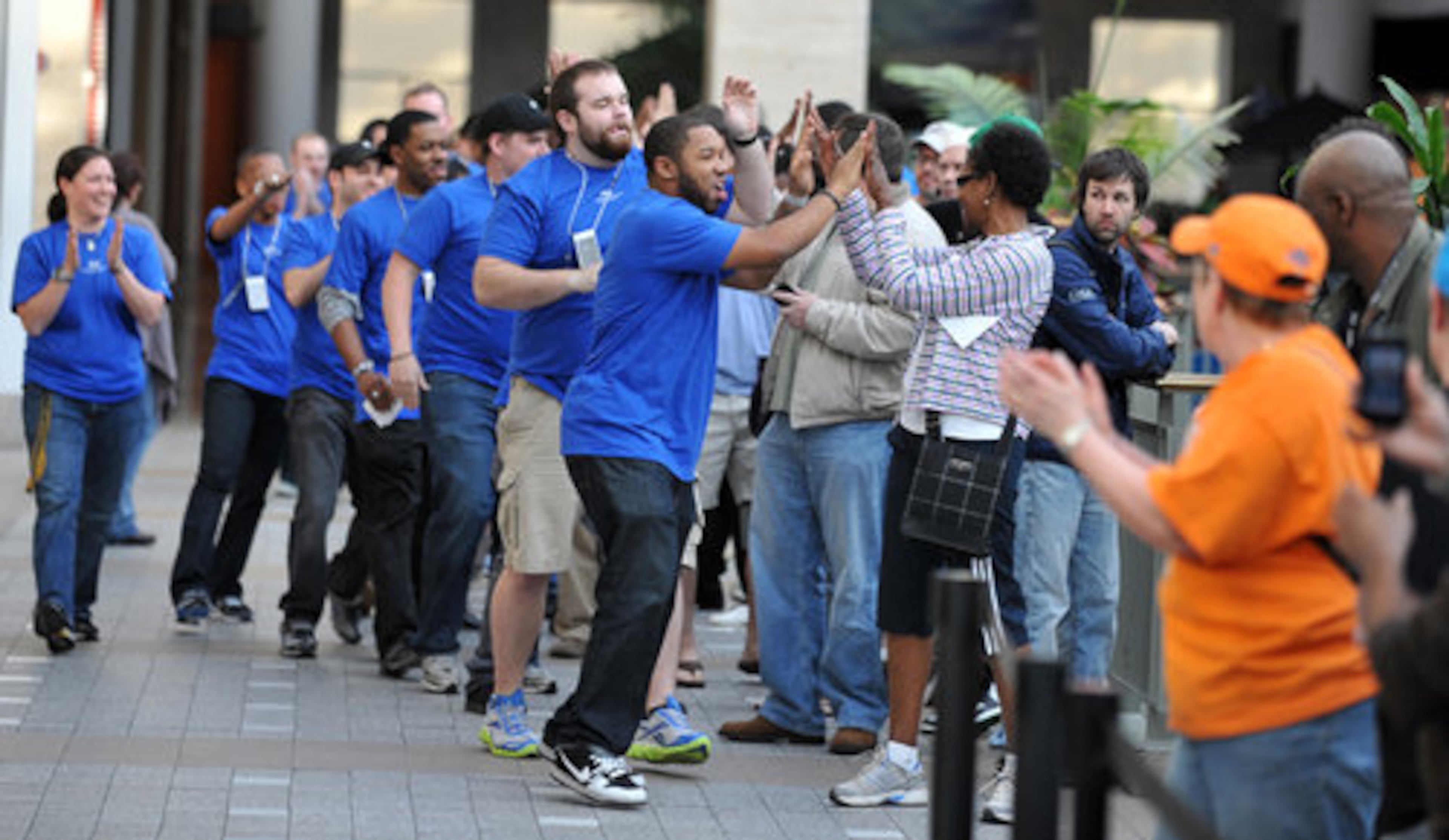 Apple Store employees excited the crowd moments before the store opened to sell the new iPad at the Apple Store in Lenox Square. More than 200 people lined up, some arriving as early as 5 a.m., to purchase Apple's latest technological craze.