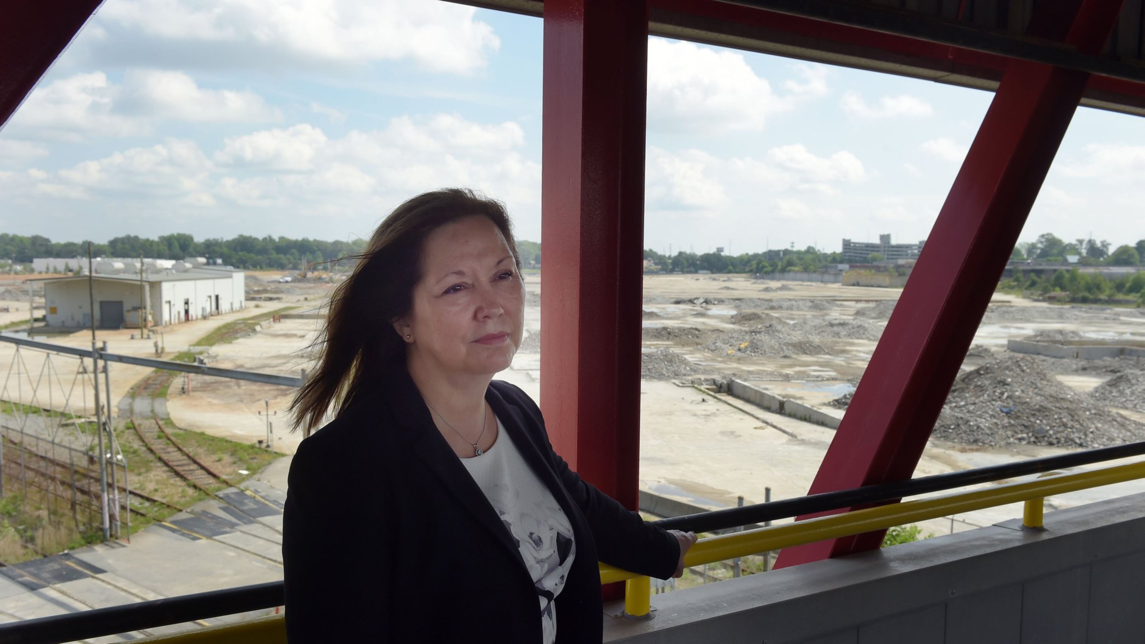 Doraville Mayor Donna Pittman walks through the construction site of Third Rail Studios, one of the first developments at the former General Motors site, on Monday. Pittman and developers are asking the DeKalb County school board to approve financial support for infrastructure on the site. KENT D. JOHNSON /kdjohnson@ajc.com