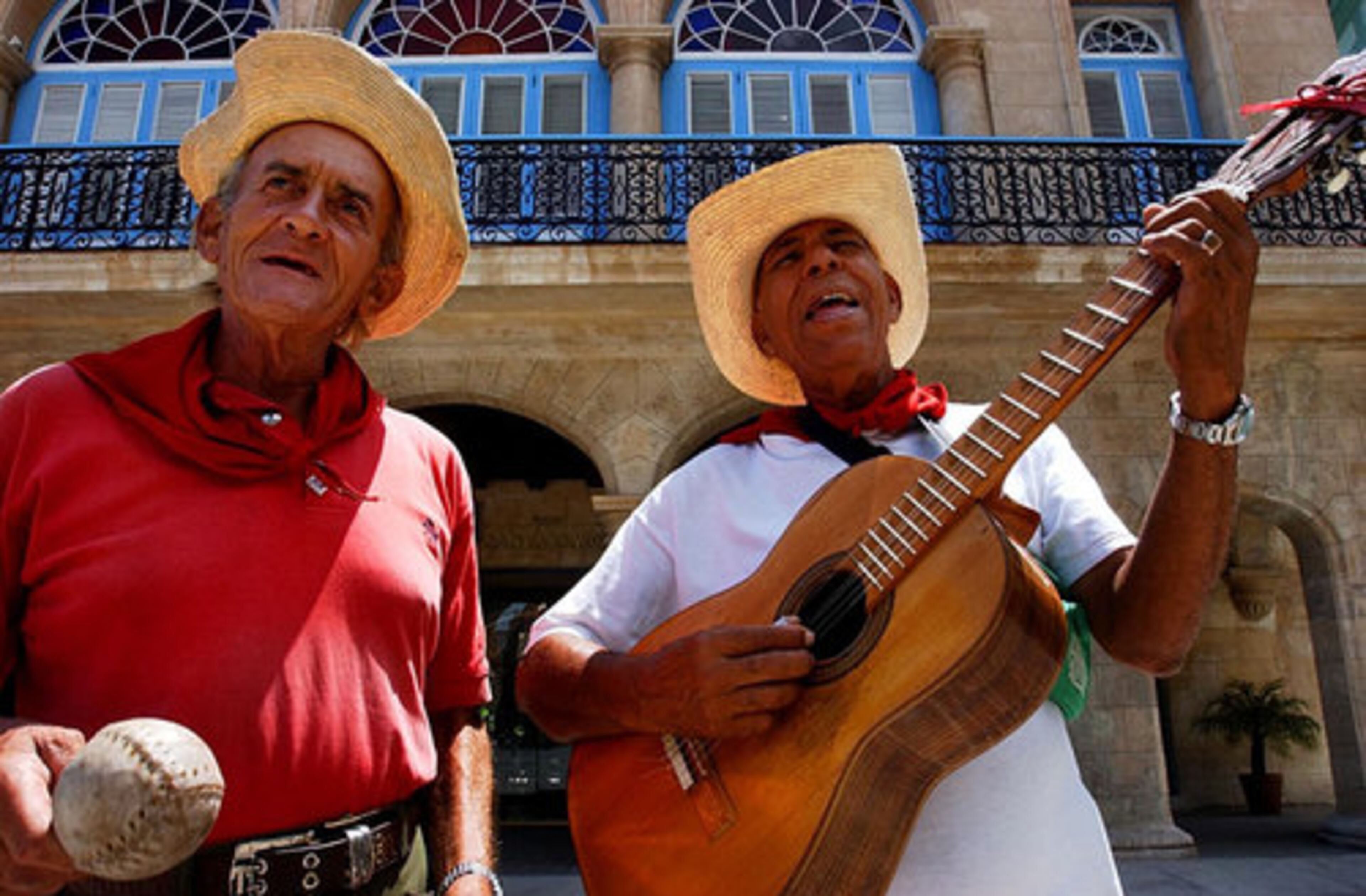 The sounds of Havana can be heard nearly everywhere in the old city as the island moves to its own rhythm and beat. Street musician Nestor Sosa plays a marimba made out of a softball while guitarist Alberto Norona sings for passers by in 2002.