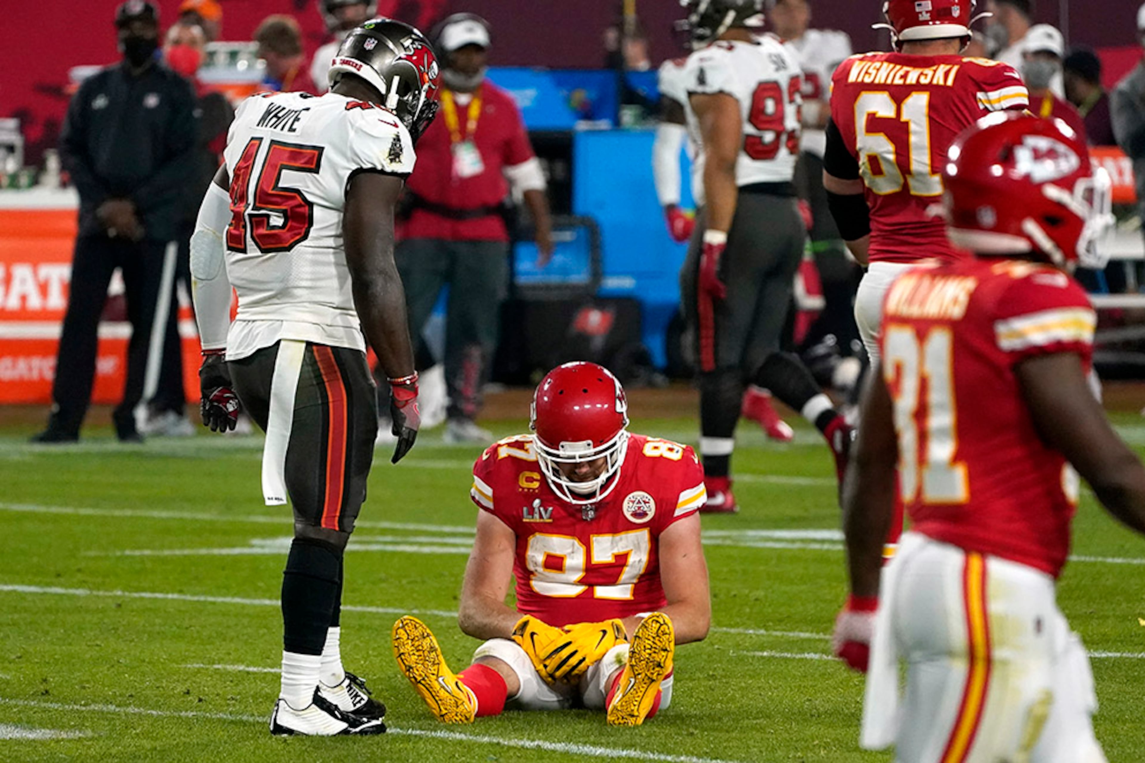 Kansas City Chiefs tight end Travis Kelce (87) sits on the field after an incomplete pass as Tampa Bay Buccaneers inside linebacker Devin White (45) looks on in the second half of Super Bowl 55 Sunday, Feb. 7, 2021, in Tampa, Fla. (Gregory Bull/AP)