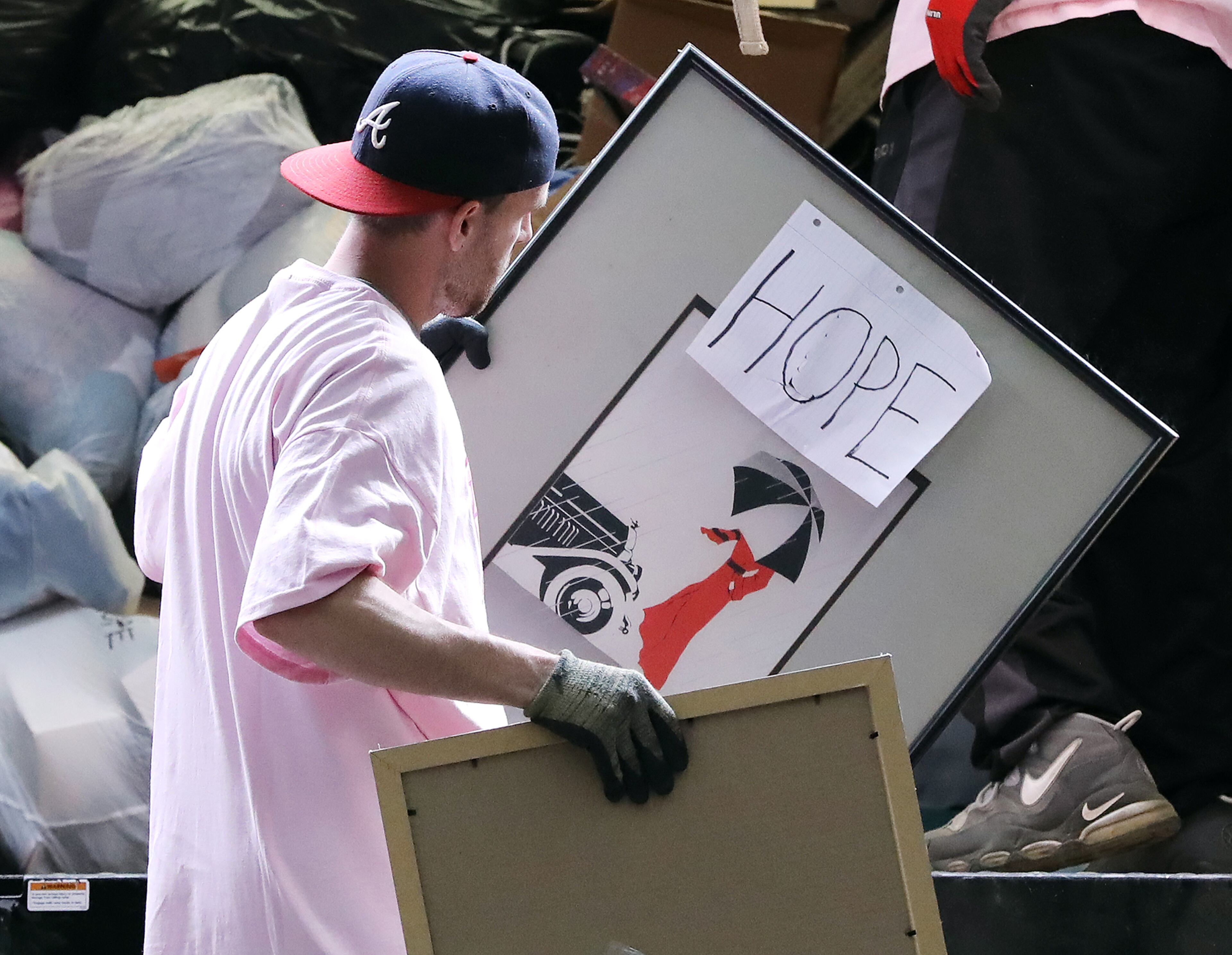 March 30, 2020 Duluth: Formerly homeless graduate Josh Steedly helps unload donated items from a truck at the Nspire Outreach and HOPE for Domestic Violence warehouse on Monday, March 30, 2020, in Duluth. With so many counties and cities ordering folks to shelter-in-place, many have found its a good time to clear out clutter. But then what do you do with it? Several charitable organizations are still doing pickups. Viewed as essential services because they are providing food, clothing and shelter to the homeless and those in need. Curtis Compton ccompton@ajc.com