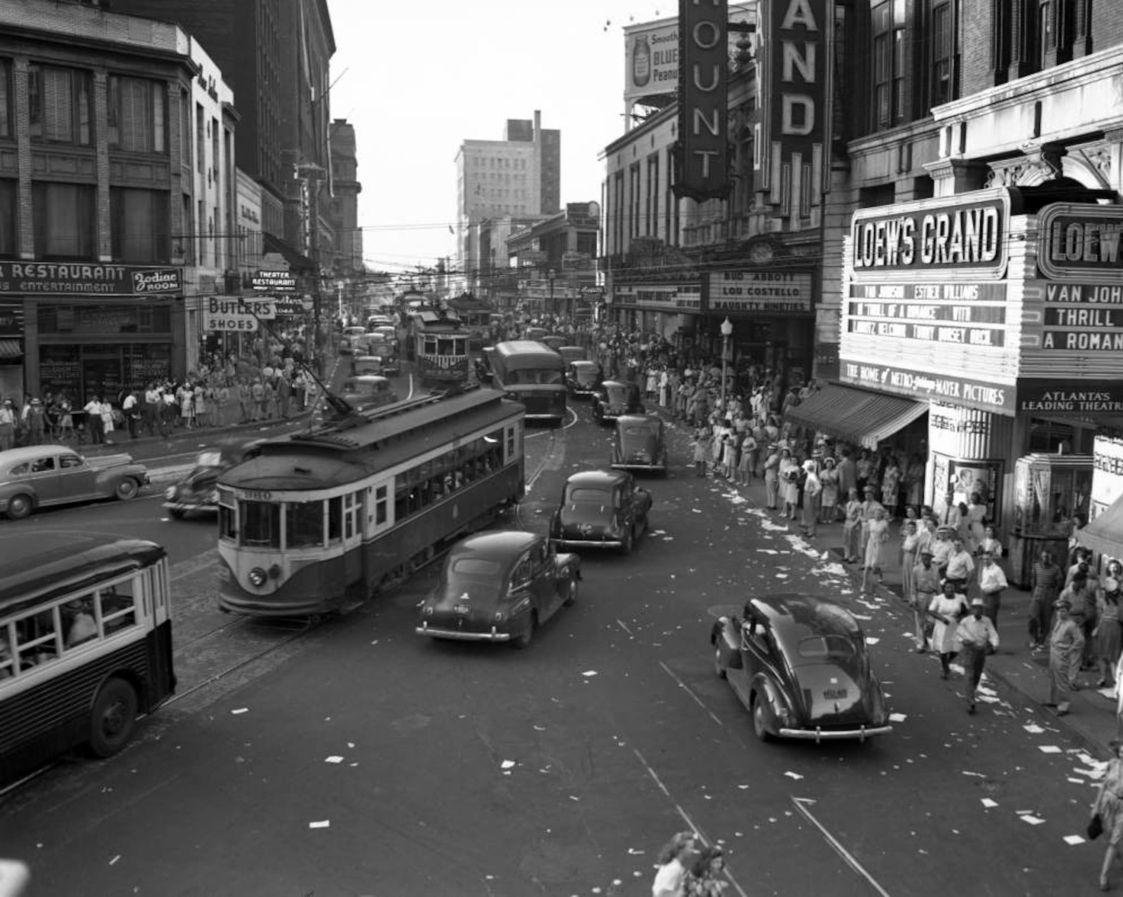 Aftermath of the celebration of V-J Day ("Victory over Japan Day") on Peachtree Street in Atlanta on August 14, 1945. The Loew's Grand Theatre is on the right.