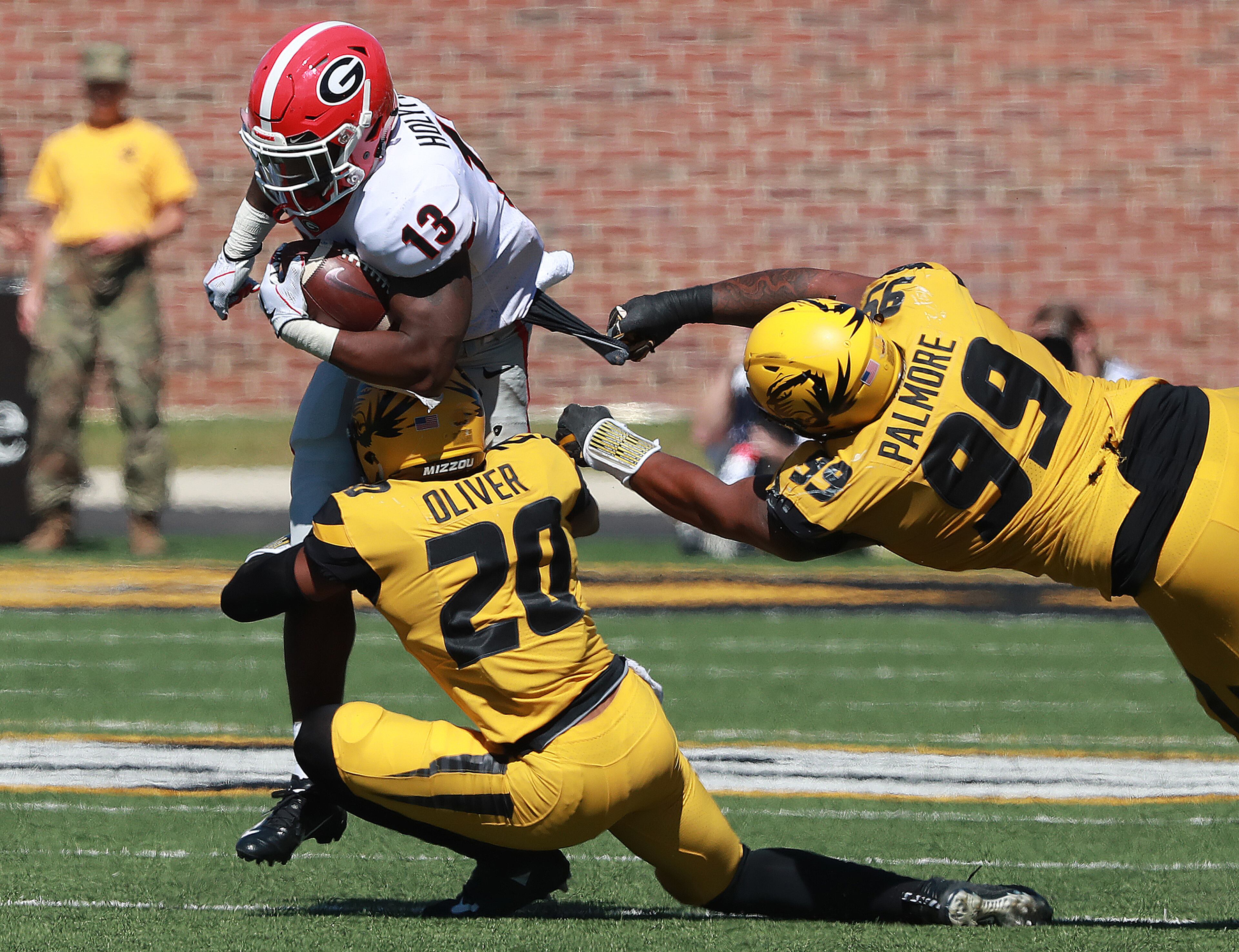 September 22, 2018 Columbia: Georgia running back Elijah Holyfield picks up some hard yardage against Mizzou defenders Khalil Oliver and Walter Palmore during the second half in a NCAA college football game on Saturday, Sept 22, 2018, in Columbia. Curtis Compton/ccompton@ajc.com