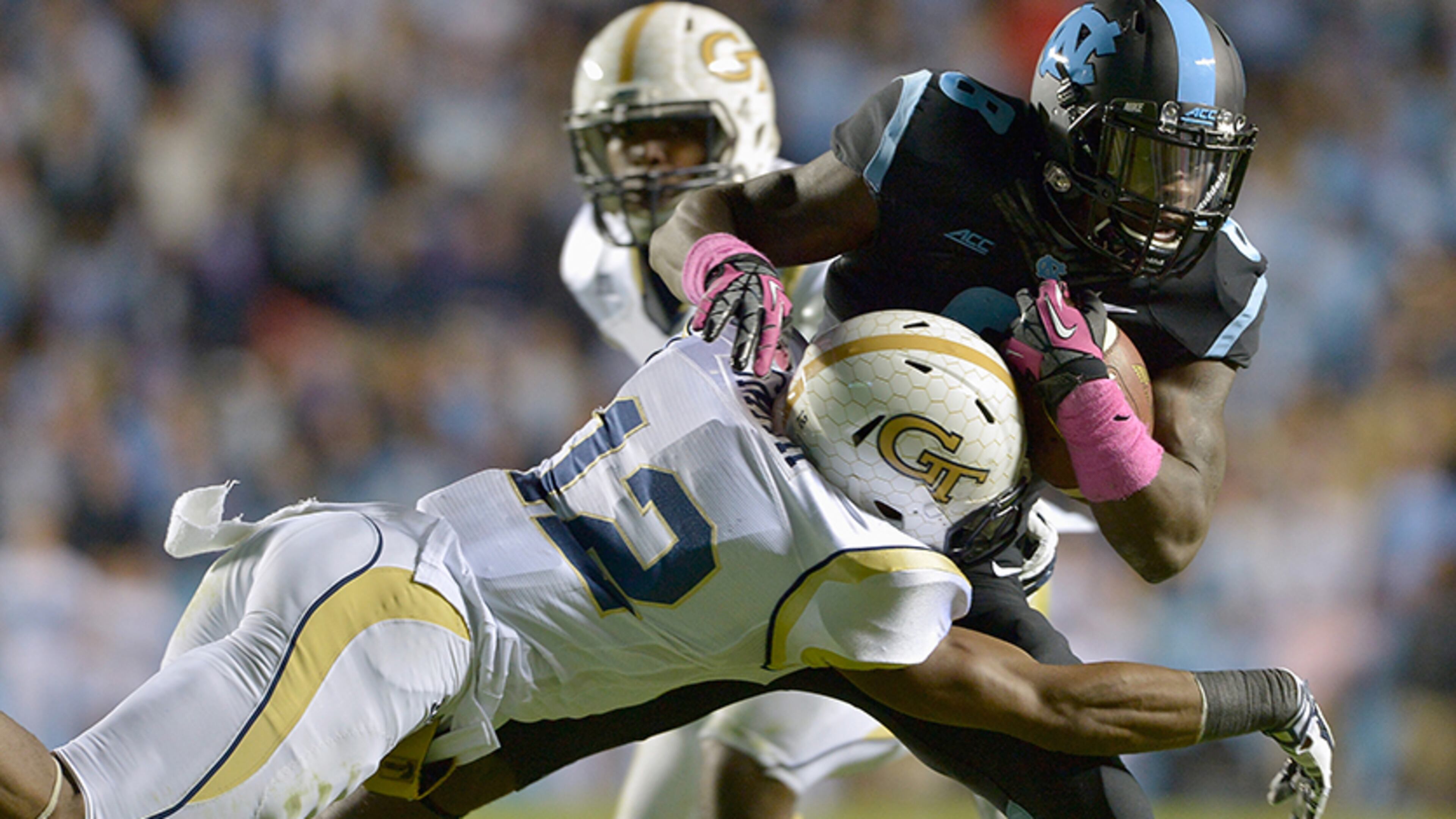 Demond Smith (12) makes a diving tackle to bring down the Tar Heels' T.J. Logan at Kenan Stadium on Oct. 18, 2014, in Chapel Hill, N.C.