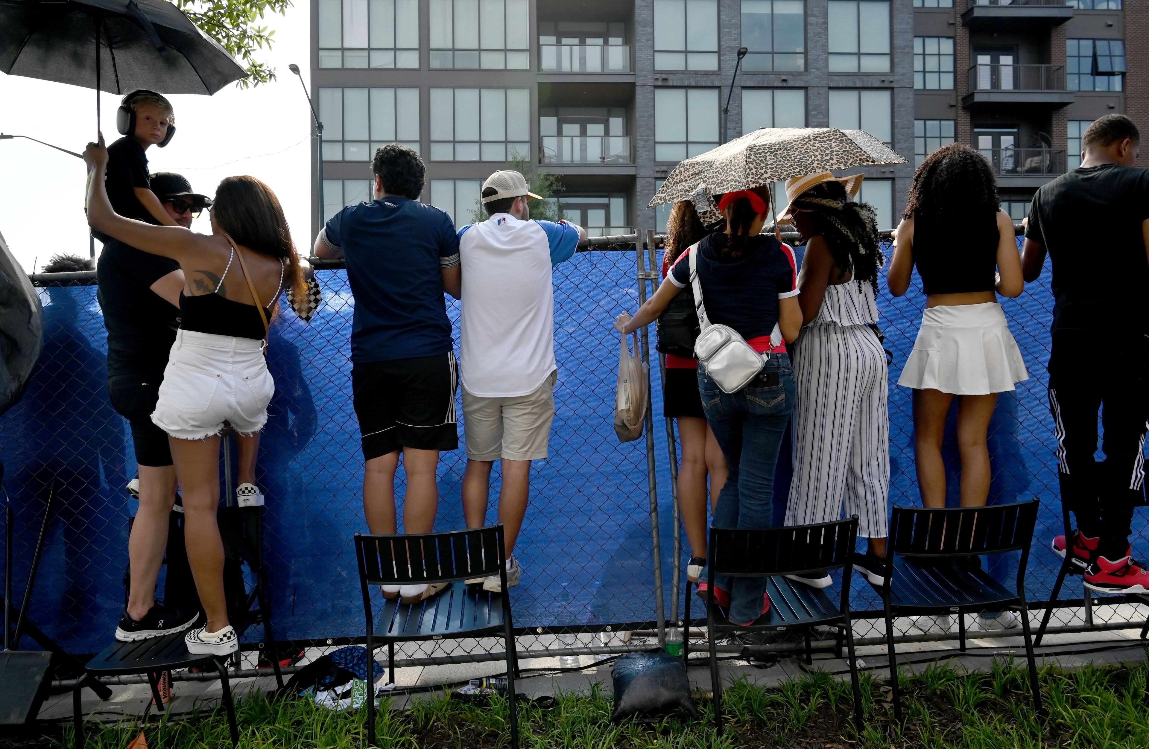 Spectators stand on chairs to watch a demonstration run on Hank Aaron Drive during the Red Bull Showrun Atlanta Presented by Ford Racing on Saturday, Aug. 1, 2026, in Atlanta. Atlanta city officials this week approved permits for the Red Bull Showrun that will allow the live motorsports demonstration event to go on as advertised along a roughly half-mile stretch of Hank Aaron Drive — a backup location after earlier plans to hold the event near Piedmont Park ran into opposition from Midtown residents. (Hyosub Shin/AJC)