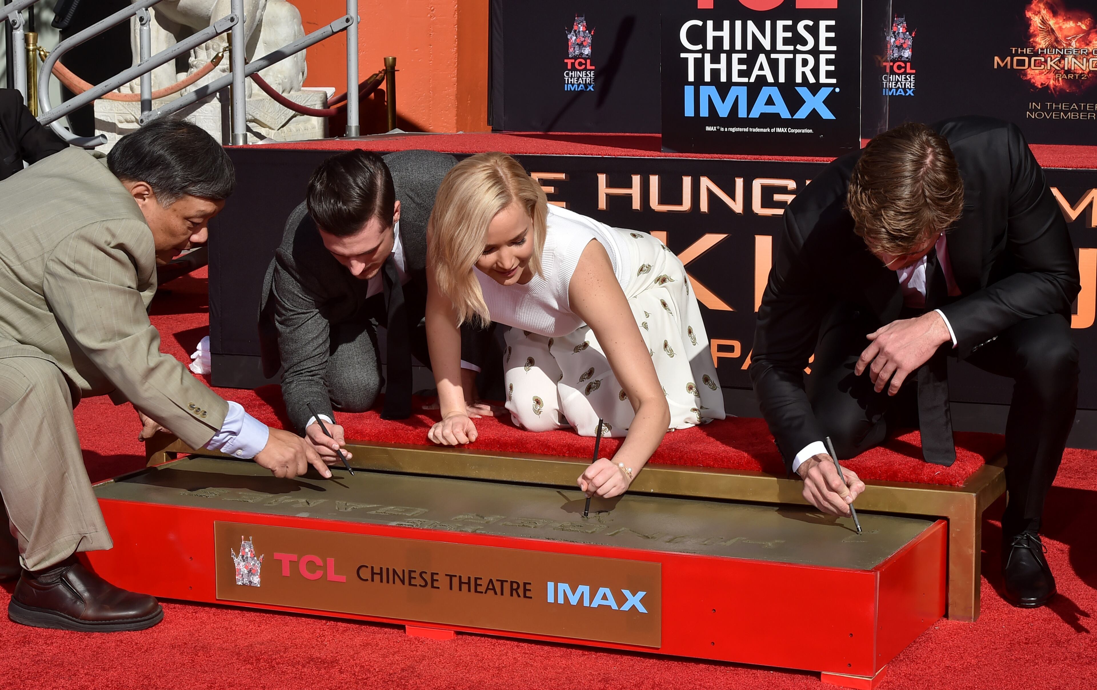 HOLLYWOOD, CA - OCTOBER 31: (L-R) Actors Josh Hutcherson, Jennifer Lawrence and Liam Hemsworth attend Lionsgate's "The Hunger Games: Mockingjay - Part 2" Hand and Footprint Ceremony at TCL Chinese Theatre on October 31, 2015 in Hollywood, California. (Photo by Kevin Winter/Getty Images)