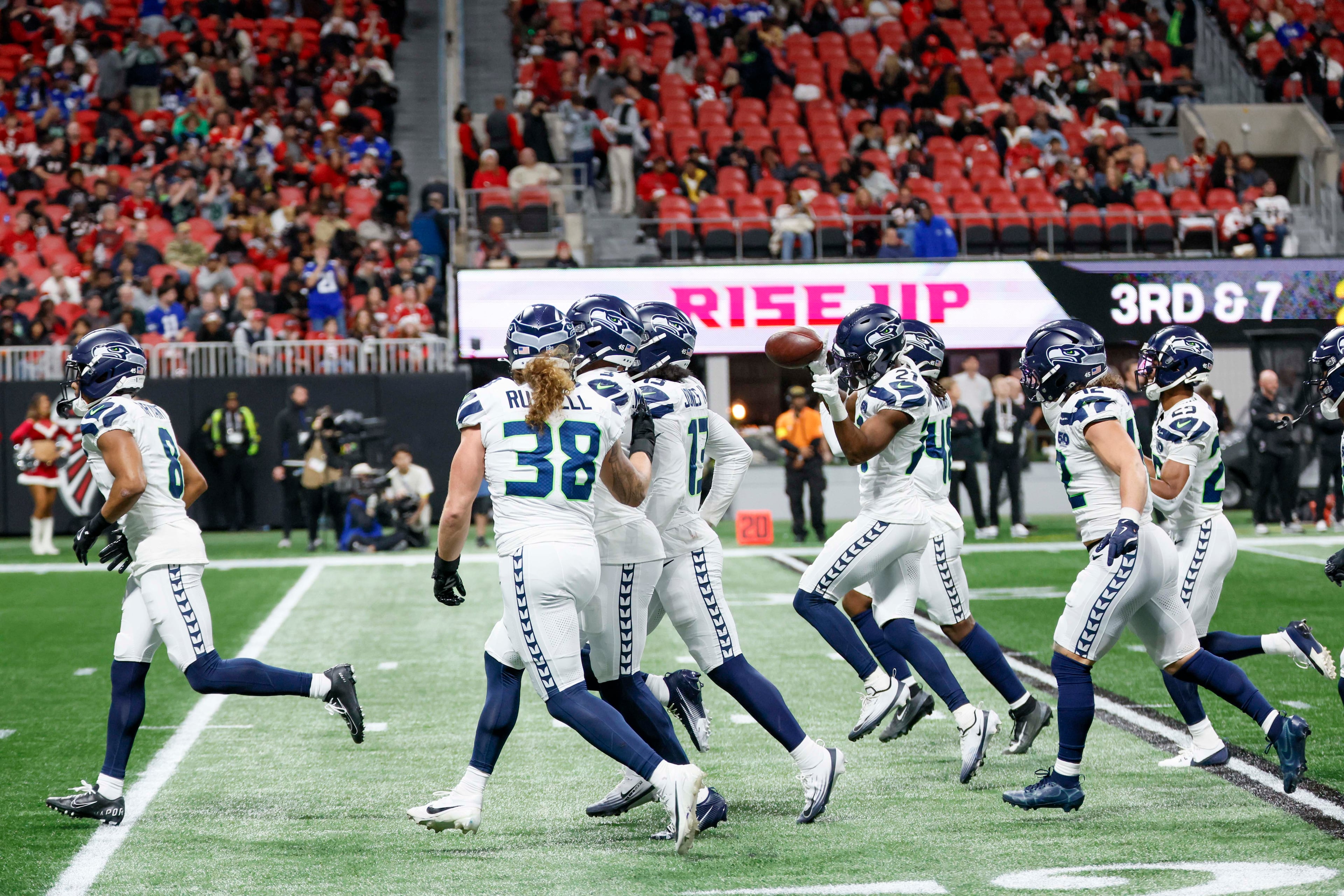 Seattle Seahawks players celebrate after an interception by Seahawks cornerback Devon Witherspoon (21), center, during the second half of an NFL game against the Atlanta Falcons at Mercedes-Benz Stadium in Atlanta on Sunday, Dec. 7, 2025.
(Miguel Martinez/ AJC)