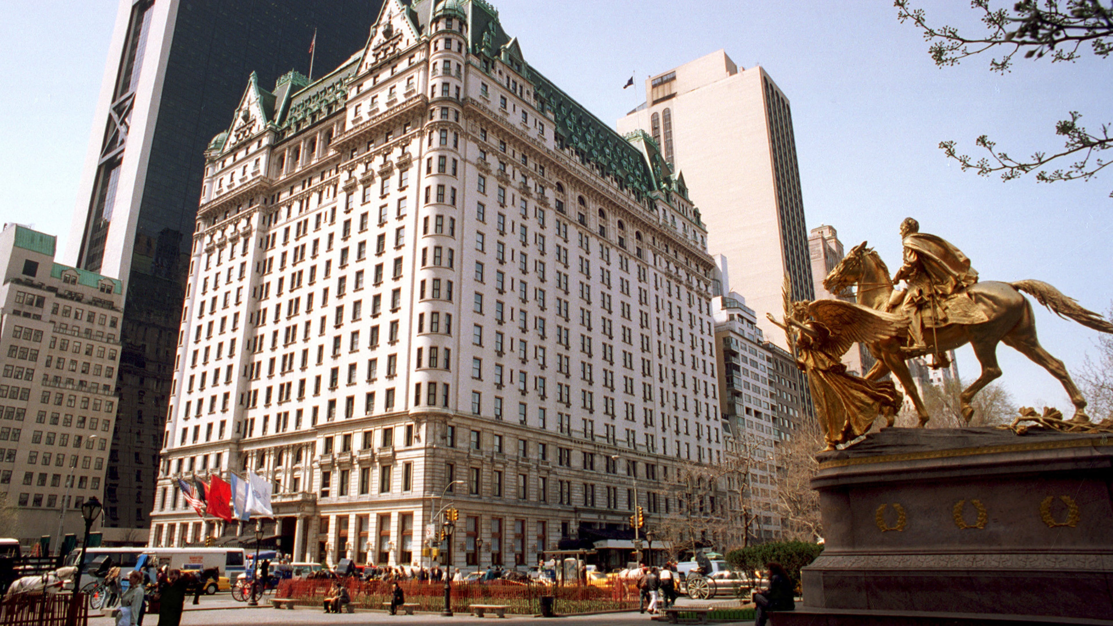 FILE - Pedestrians walk in front of the Plaza Hotel in New York, April 11, 1995. (AP Photo/Marty Lederhandler, File)