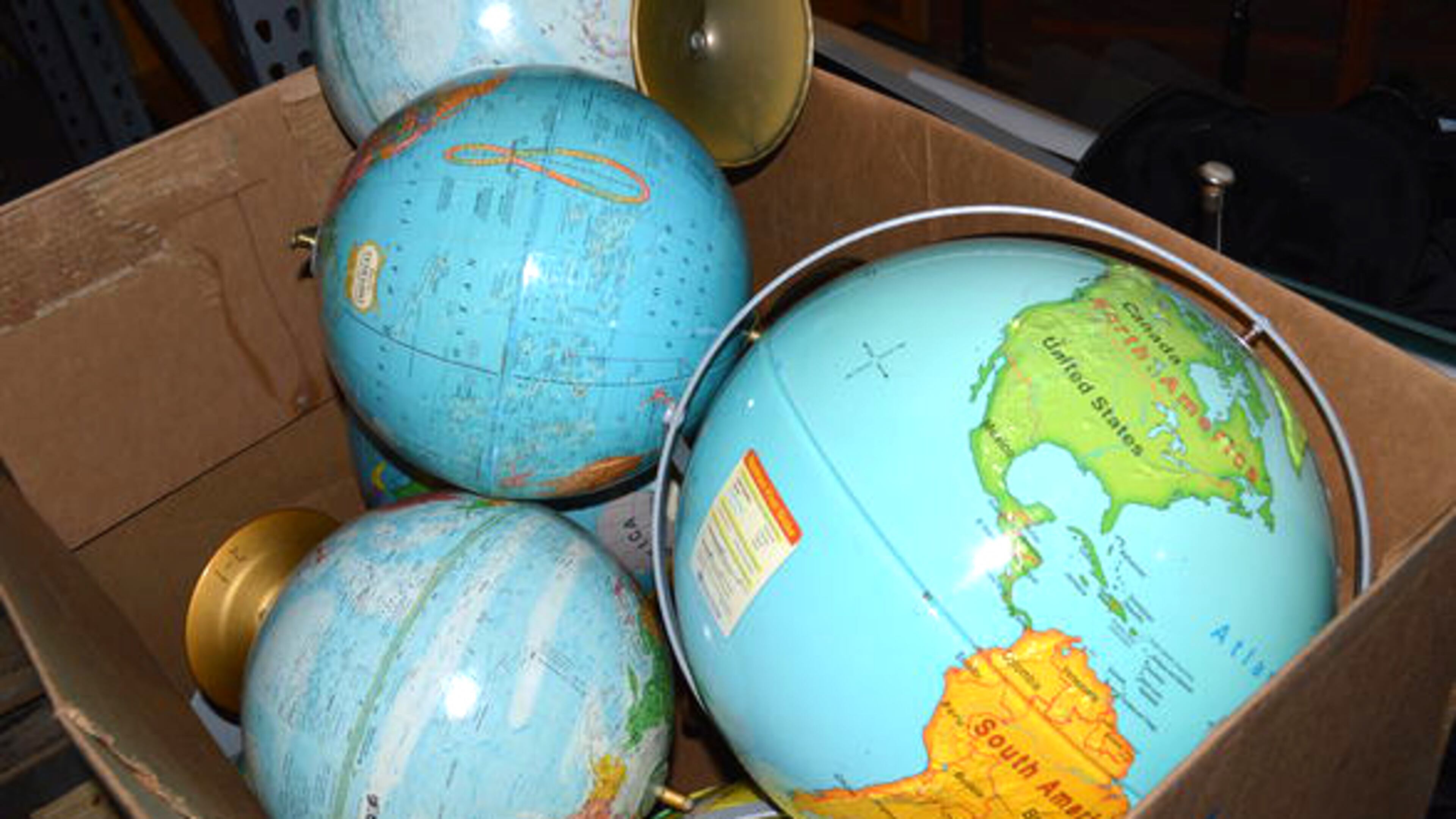 A bin of classroom globes are among the items the Cherokee County Schools plan to sell at auction Nov. 5. JEFF DOBSON & ASSOCIATES