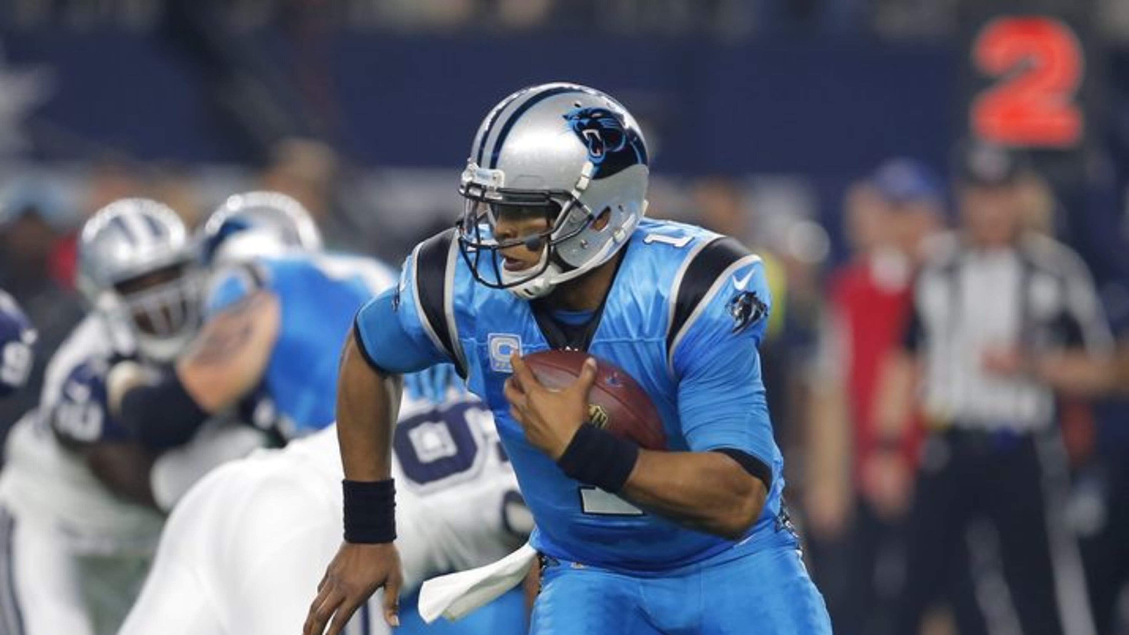 Carolina Panthers quarterback Cam Newton (1) runs the ball under pressure from the Dallas Cowboys during a NFL football game, Thursday, Nov. 26, 2015, in Arlington, Texas. (AP Photo/Brandon Wade)