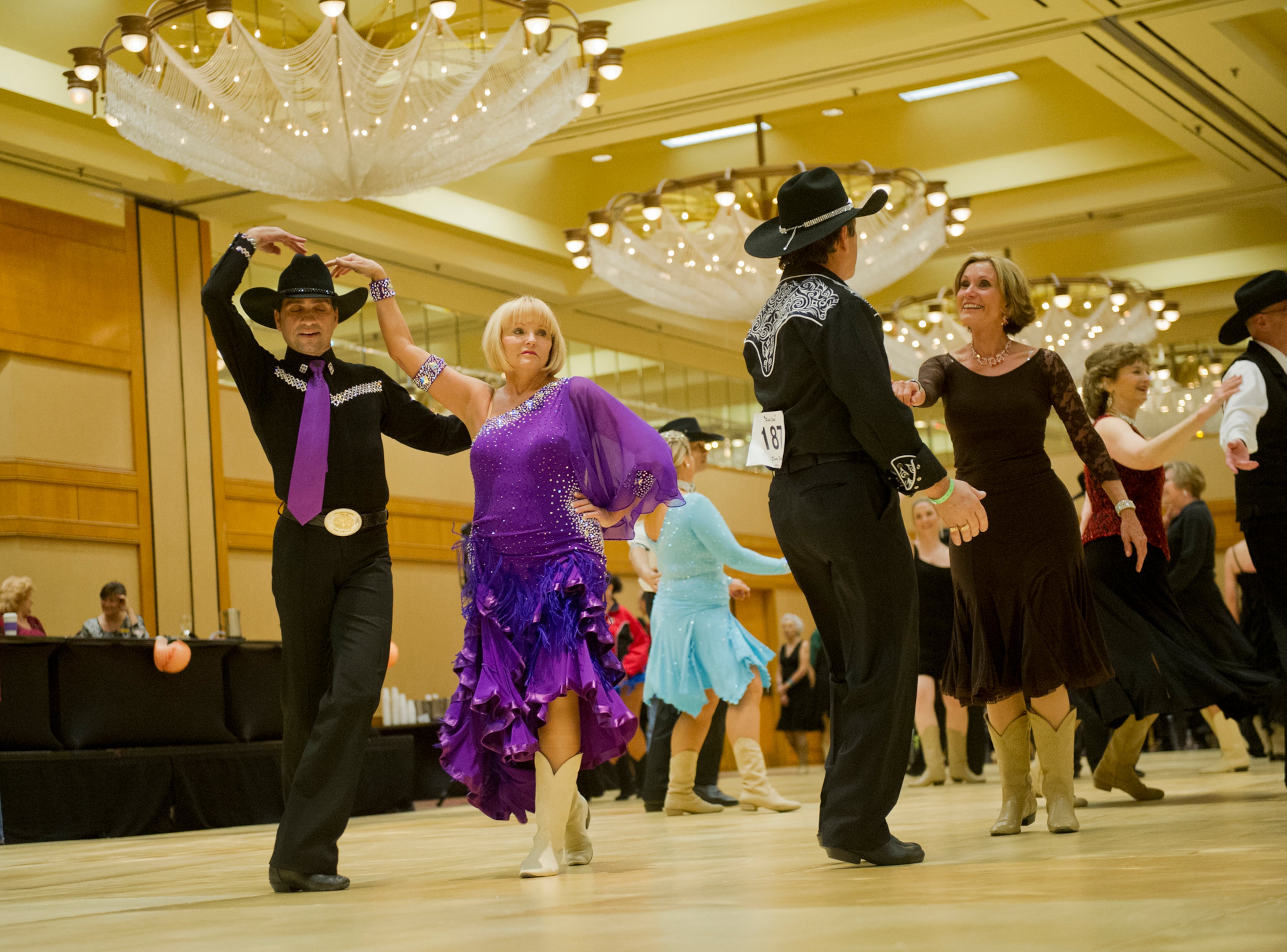 Anthony Ferrara (left) dances with partner Peggy Fisher during the Peach State Dance Festival at the Crown Plaza Ravinia hotel in Atlanta on Saturday, March 22, 2014. Approximately 1,000 country, swing and line dancers filled the hotel in Dunwoody for a weekend of instruction, competition, social dancing, and dance performances. The festival is in its 24th year and is the largest of its kind in the southeast.