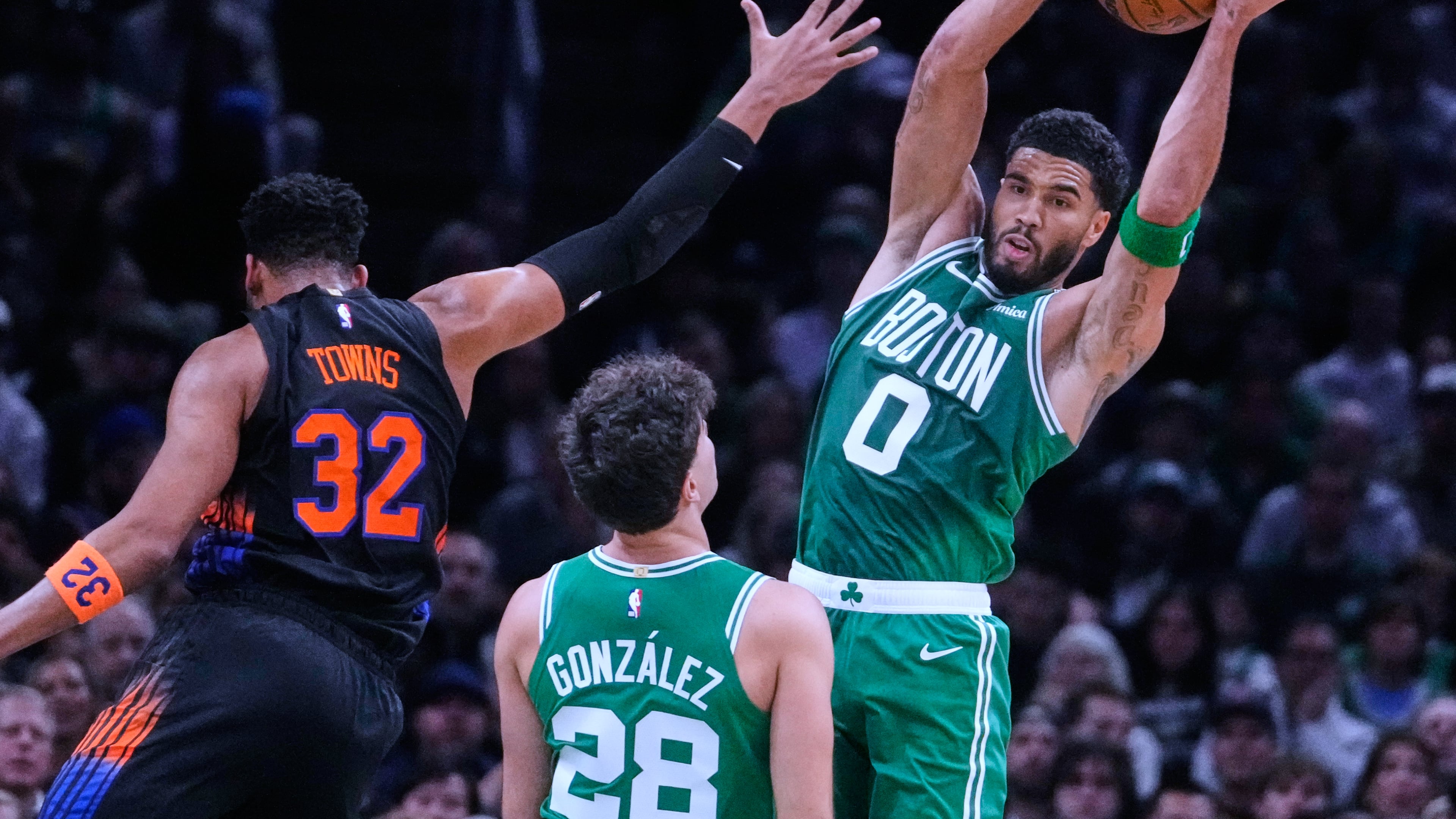 Boston Celtics' Jayson Tatum (0) grabs a rebound against New York Knicks' Karl-Anthony Towns (32) during the first half of an NBA basketball game, Friday, Oct. 23, 2026, in Boston. (AP Photo/Charles Krupa)