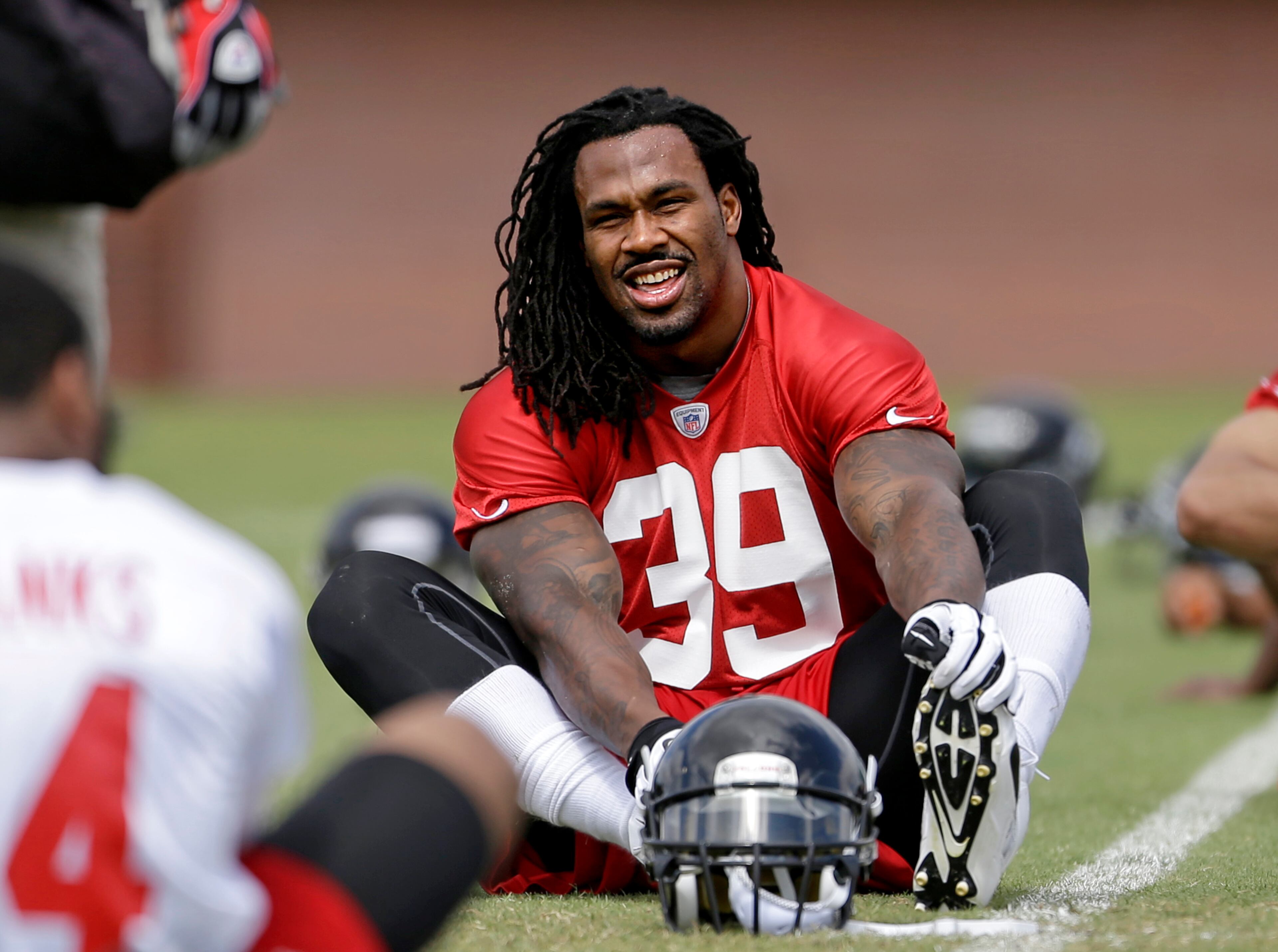 Falcons running back Steven Jackson stretches during an NFL football practice at the team's training facility, Wednesday, May 29, 2013, in Flowery Branch, Ga. (AP Photo/David Goldman)