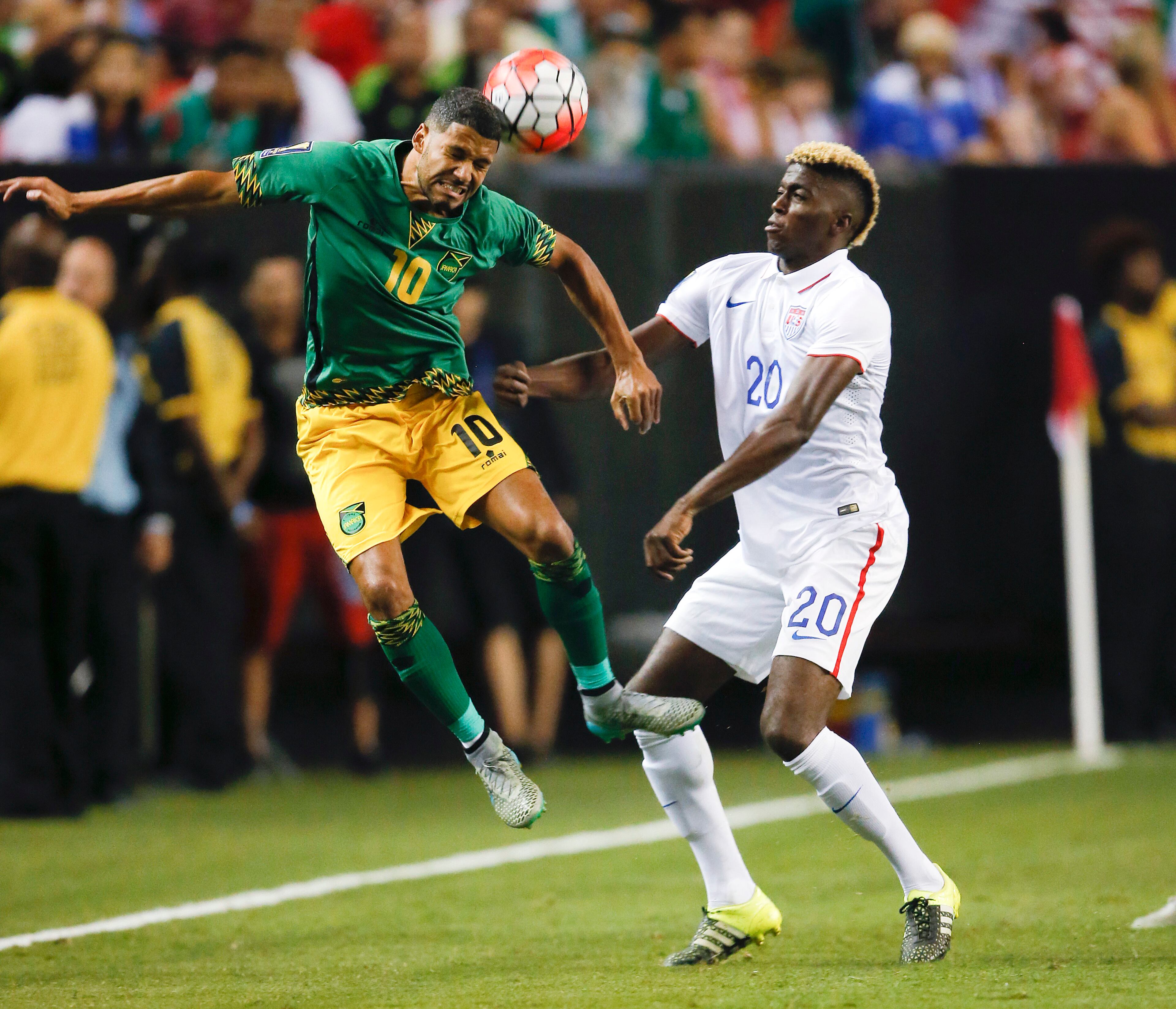 Jamaica's Joel McAnuff (10) heads the ball in front of United States' Gyasi Zardes (20) during the first half of a CONCACAF Gold Cup soccer semifinal Wednesday, July 22, 2015, in Atlanta. (AP Photo/John Bazemore)