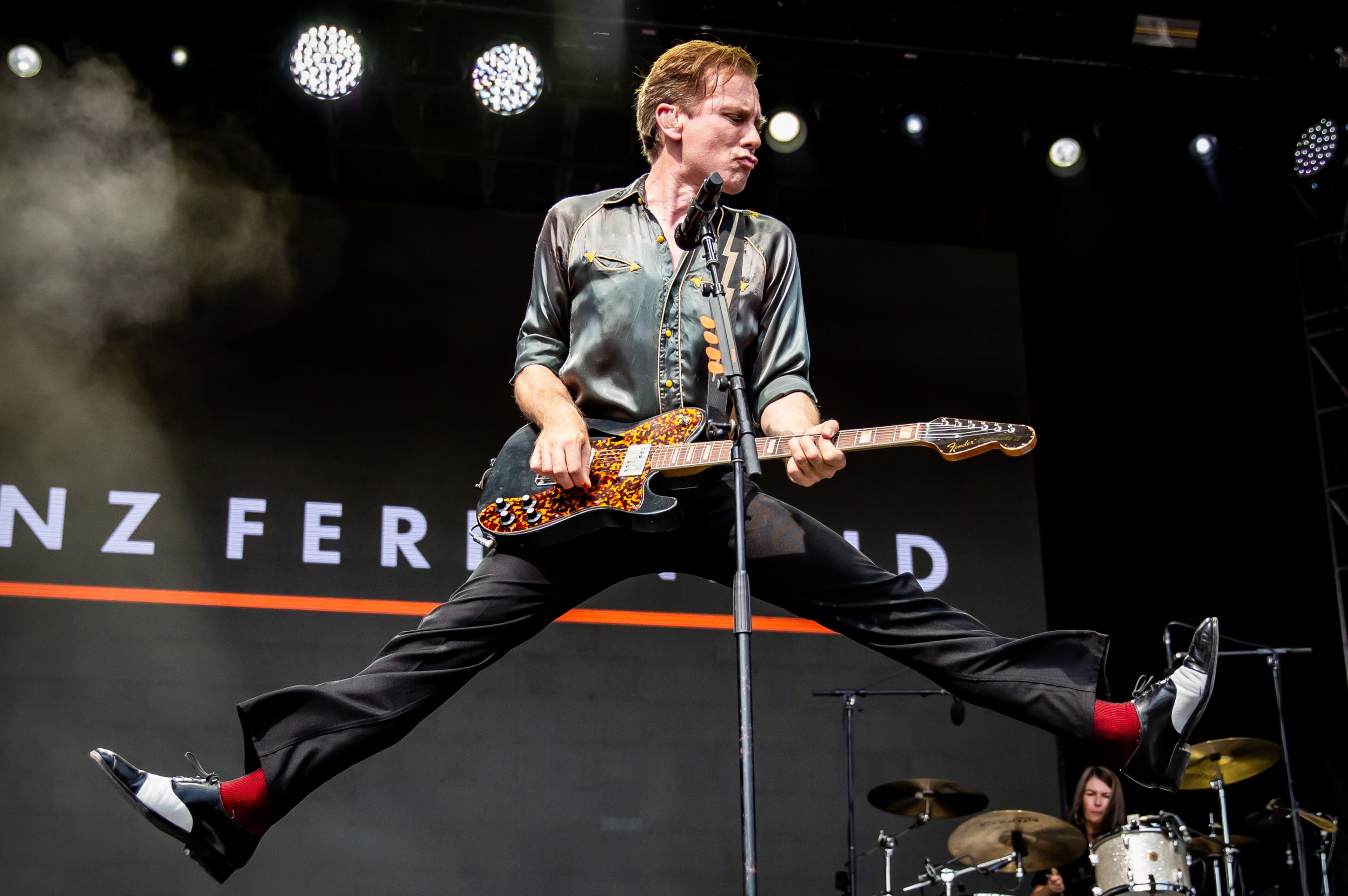 Franz Ferdinand frontman Alex Kapranos jumped around in 90 degree heat, and the Scottish band played a sizzling set of hits and other cuts from its deep catalog at the Shaky Knees Music Festival in Piedmont Park in September 2025. (Ryan Fleisher for the AJC)