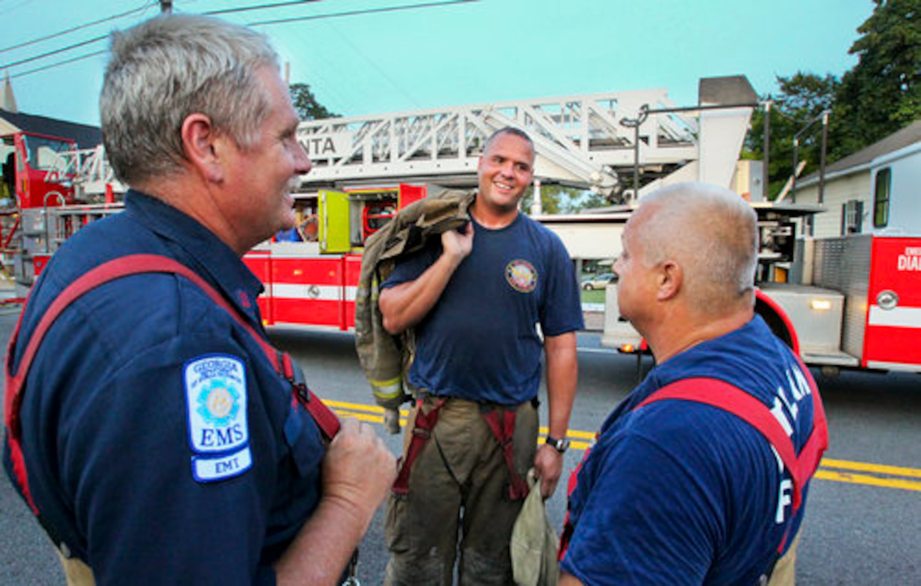 Atlanta Fire rescuers Capt. James Dycus (from left) and firefighters Rusty Glenn and Thomas Young were pretty happy following their rescue Friday. The firefighters pulled a man from the window of a burning boarding house just moments before the victim's room was consumed by flames.