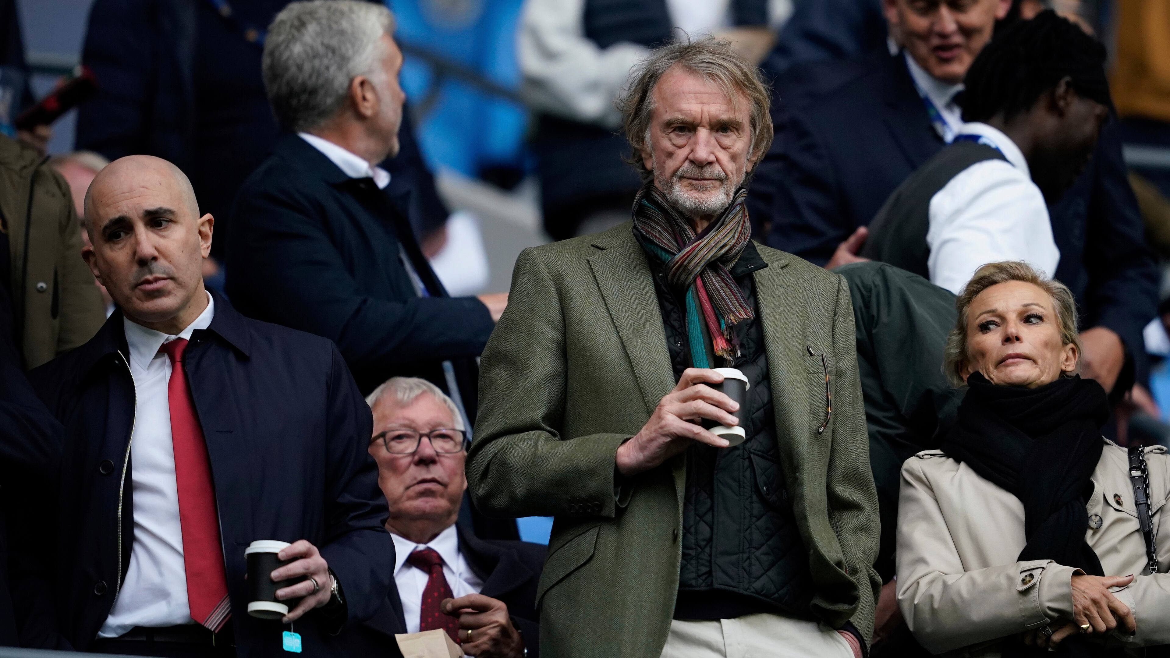 FILE - Manchster United co-owner Jim Ratcliffe stands in front of the former manager Alex Ferguson during the Premier League soccer match between Manchester City and Manchester United in Manchester, England, on Sept. 14, 2025. (AP Photo/Dave Thompson, File)