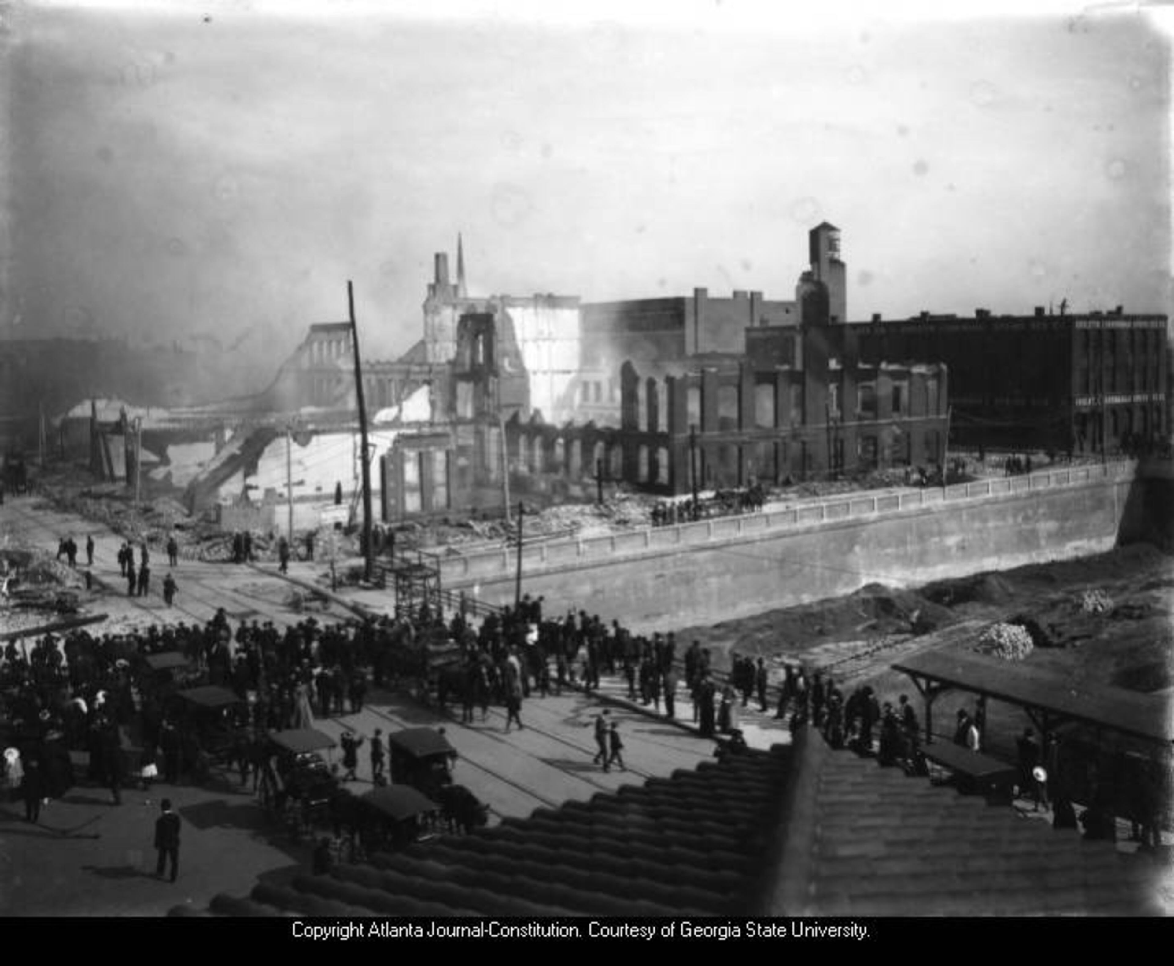 Original caption: "The Terminal district fire of May 8, 1908, left a square block of ruins. It consumed the buildings in the block bounded by Madison Avenue (Spring Street), Mitchell, Nelson and South Forsyth Streets. This picture was taken from the roof of Terminal Station. The Southern Railway Buildings had not yet been built. The Gholstin-Cunningham Spring Bed Company, right rear, across Nelson Street, was a forerunner of the Southern Spring Bed Company. The fire loss amounted to $1,250,000 and a total of 42 firms in 31 buildings were burned out." AJC PHOTO ARCHIVES