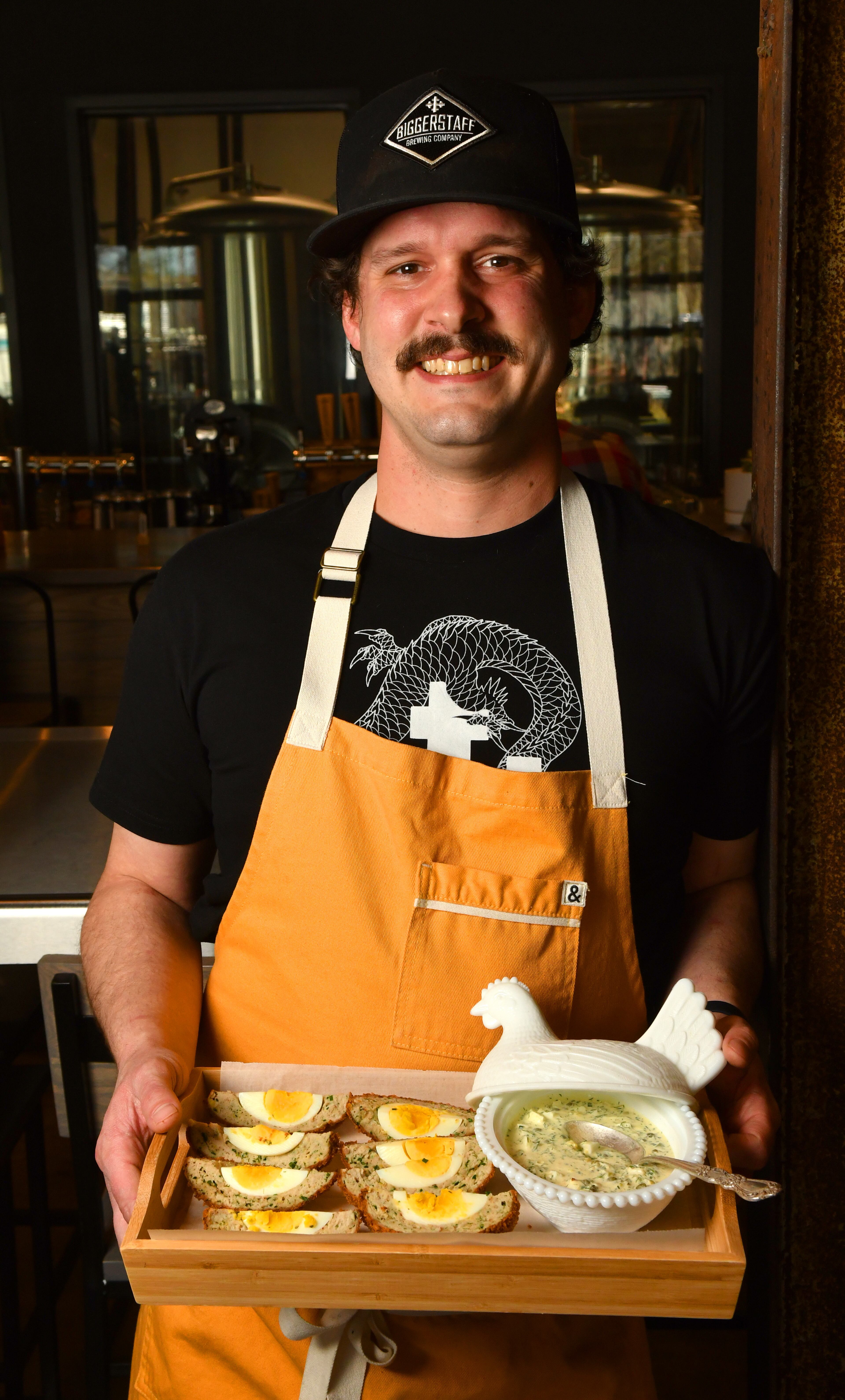 Biggerstaff Brewing Company's executive chef Davis King with his “Atlanta” Egg (a healthier version of the traditional Scotch egg) and Gribiche sauce. (Styling by executive chef Davis King / Chris Hunt for the AJC)